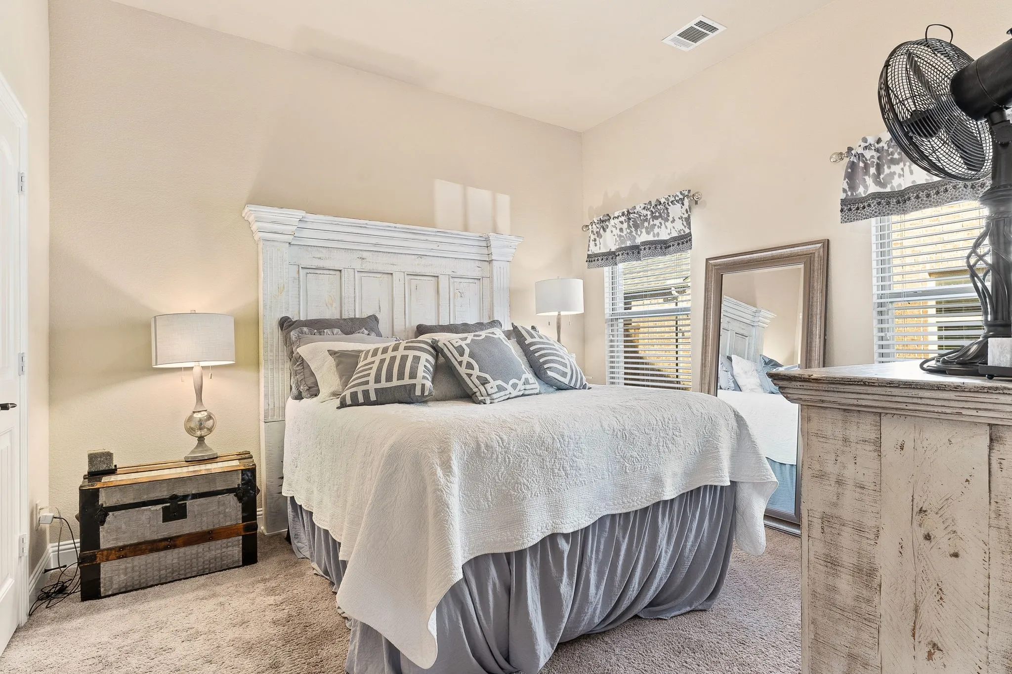 Bedroom featuring light carpet