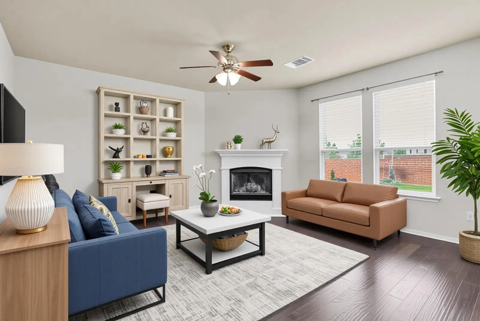 Virtual Staging -Spacious living area featuring dark wood-finish flooring, a built-in fireplace with white mantel, and ceiling fan