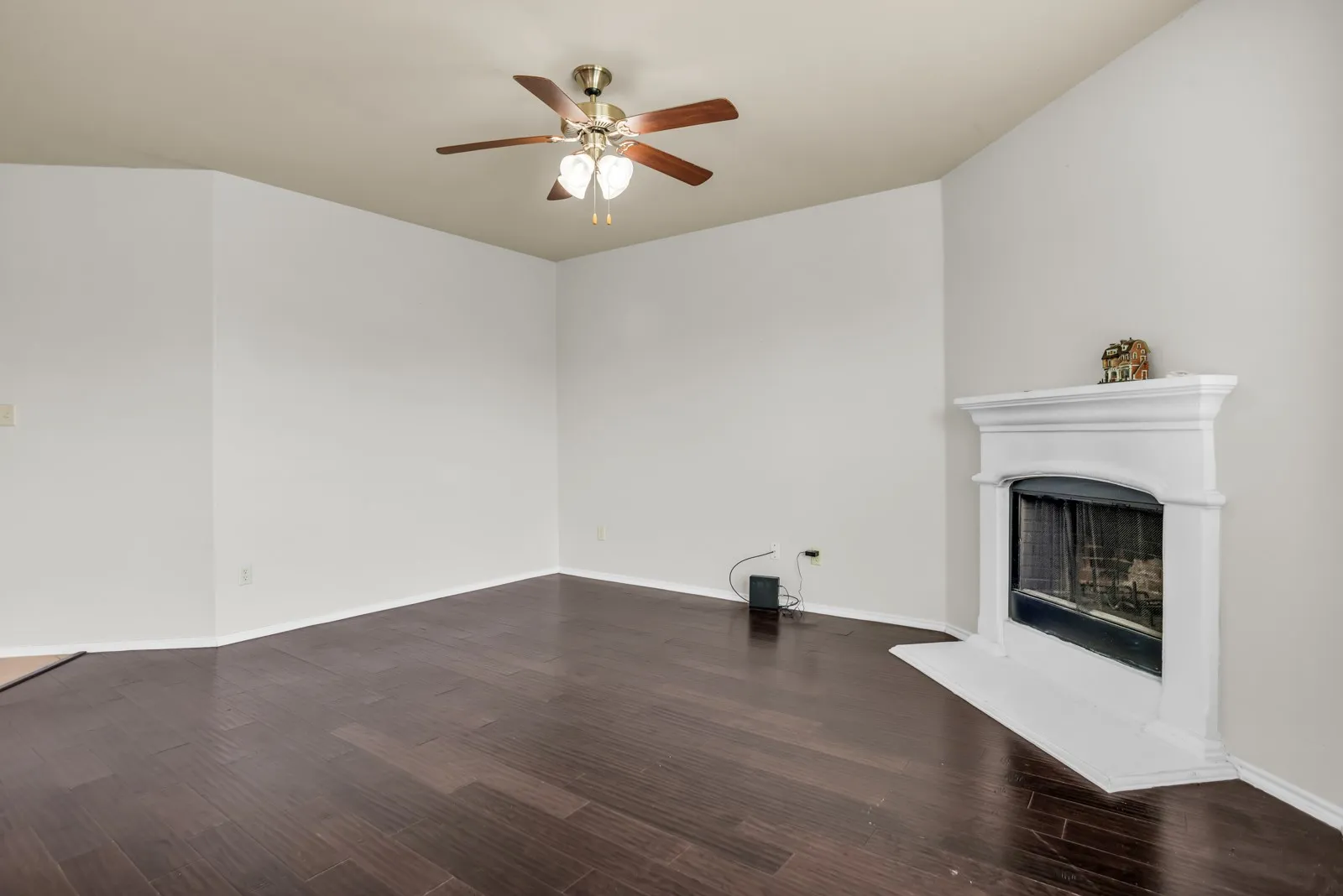 Living area featuring dark wood-finish flooring and light-toned walls