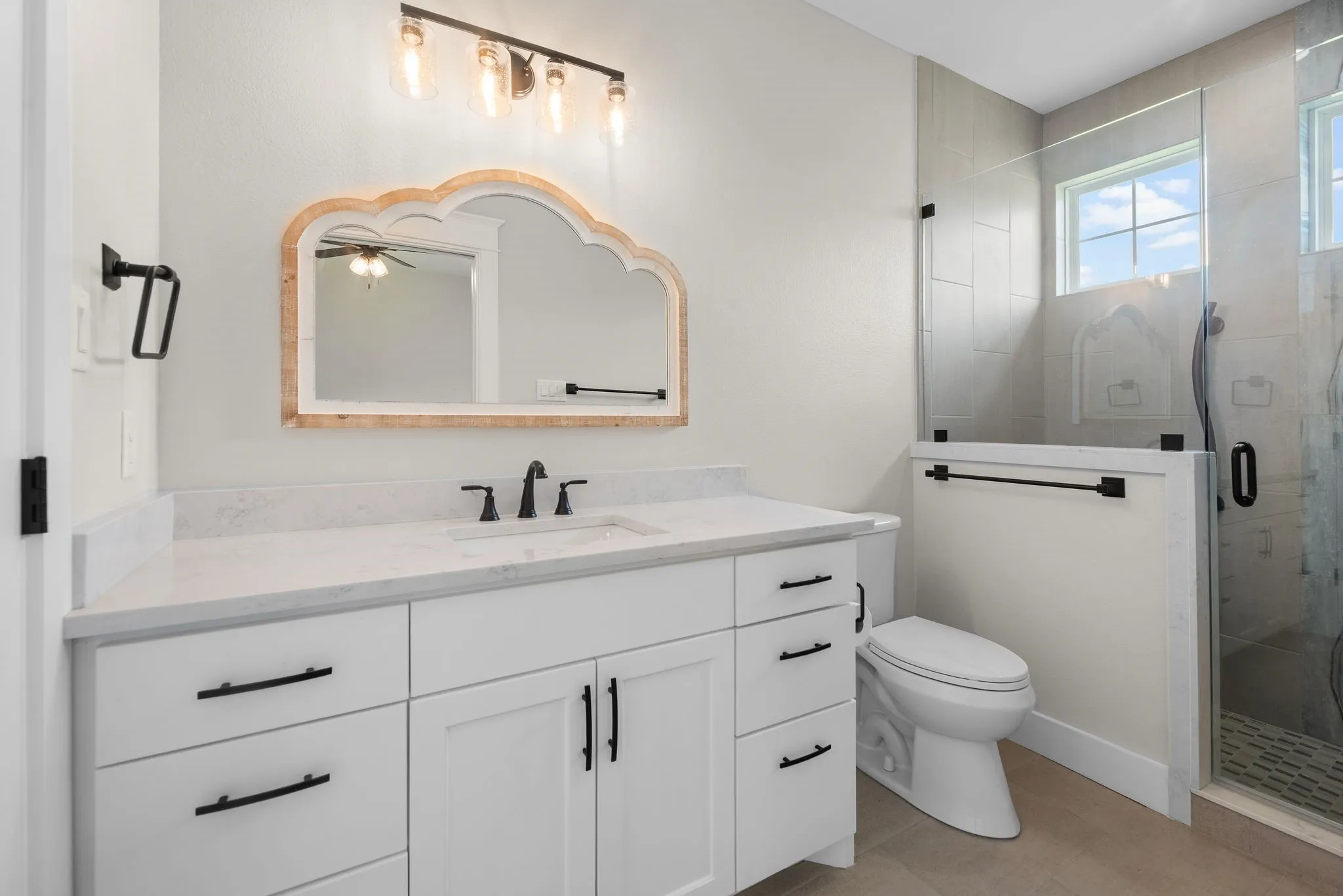 Full ensuite bathroom with dual vanity, walk-in shower, and modern finishes.