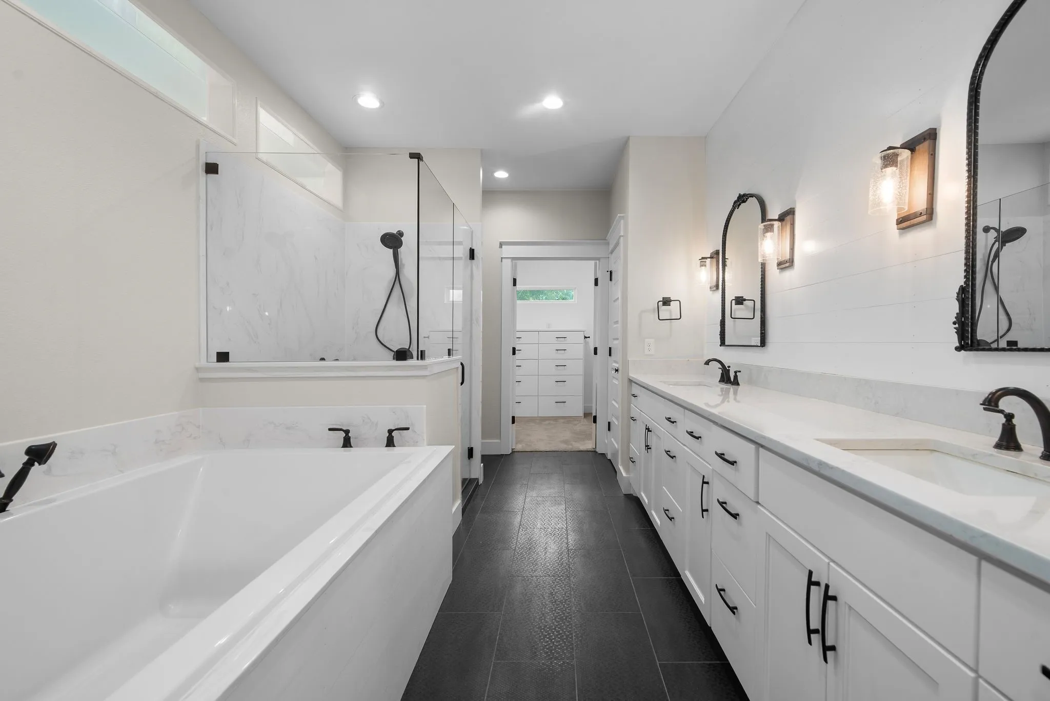 Luxury primary bathroom with soaking tub, dual sinks, and custom finishes.