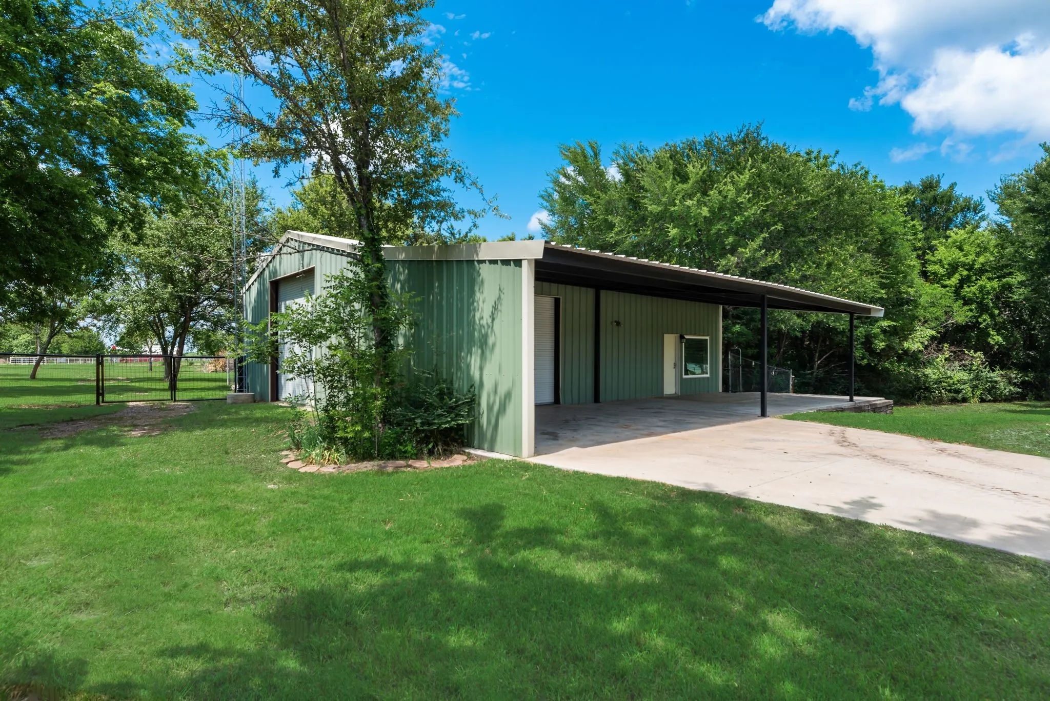 Insulated workshop with electric, roll-up doors, and climate-controlled attic storage with attached efficiency apartment guest quarters.
