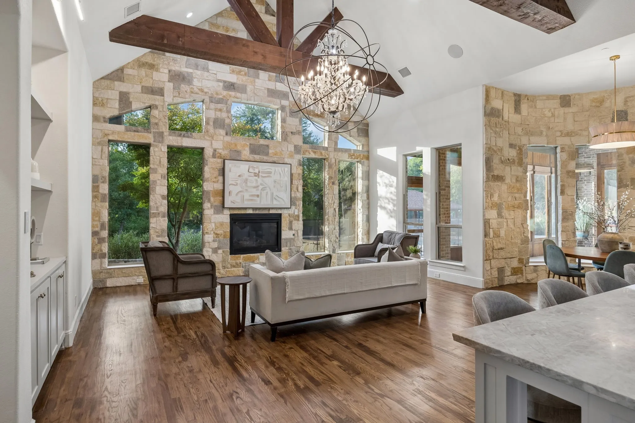 Great room with vaulted ceiling featuring exposed wood beams
