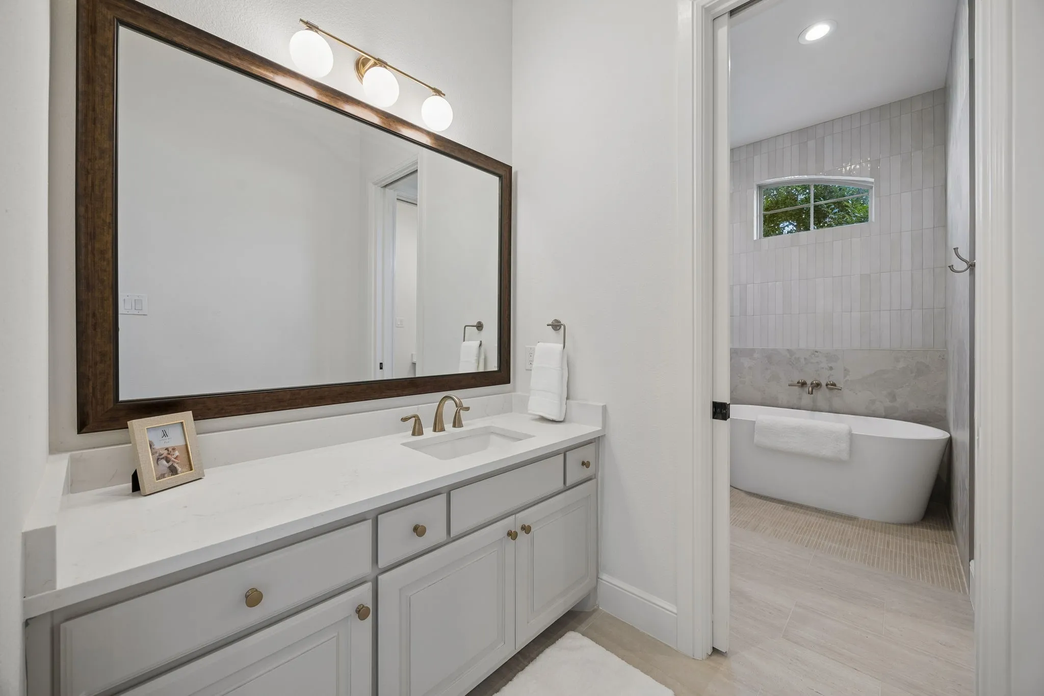 Double vanity featuring light-toned cabinetry, a white countertop, and a rectangular undermount sink