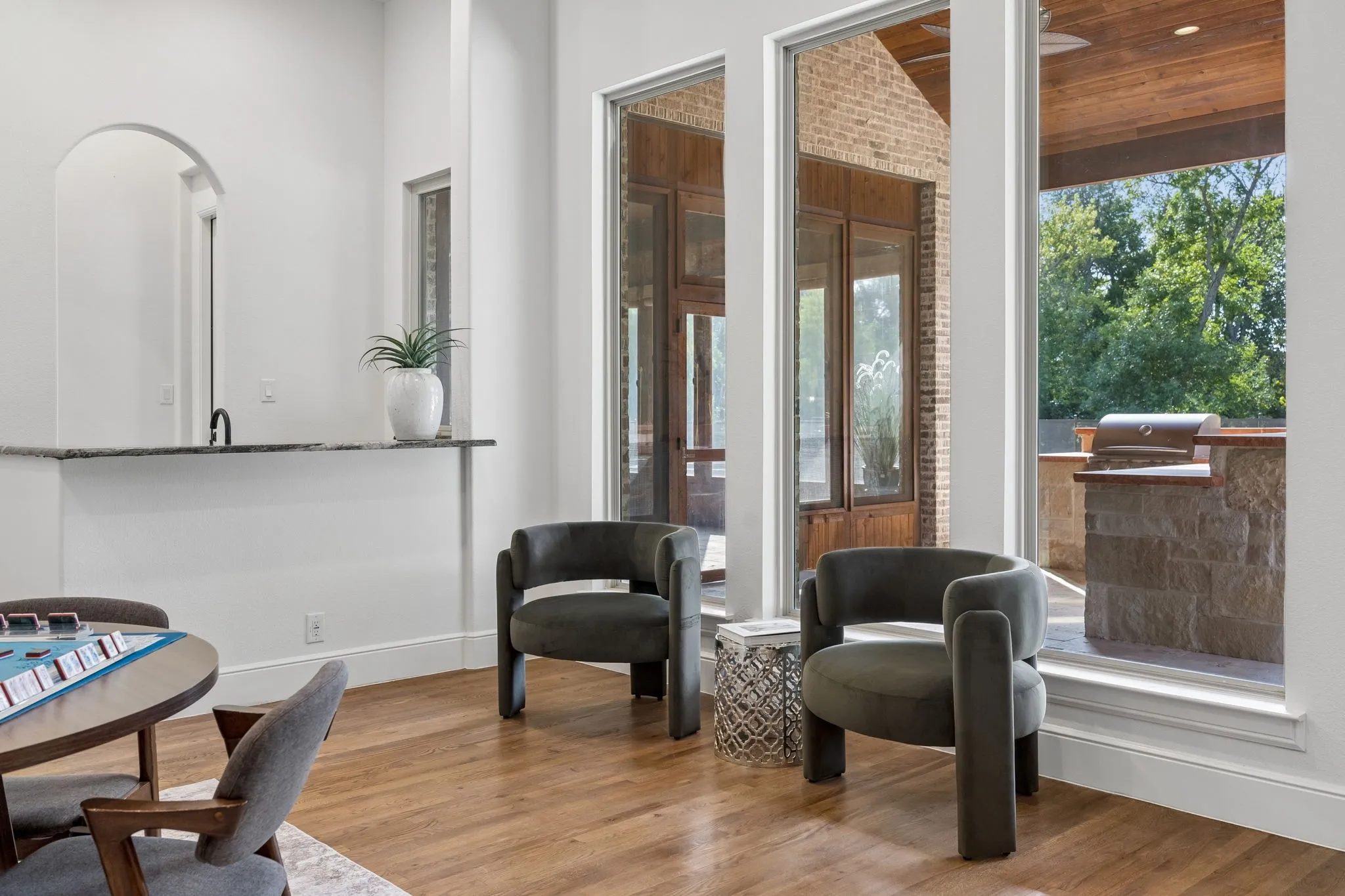 Expansive floor-to-ceiling windows with a wood-finish ceiling provide abundant natural light