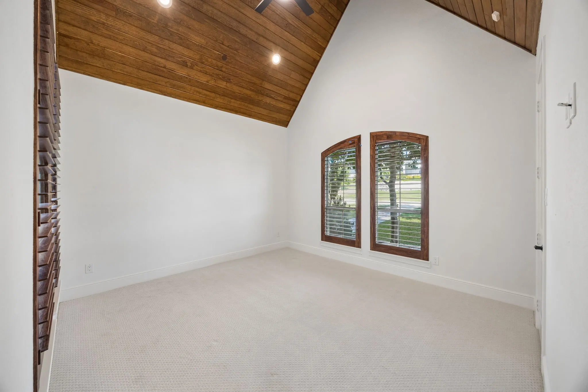 Vaulted wood-finish ceiling featuring recessed lighting and a ceiling fan