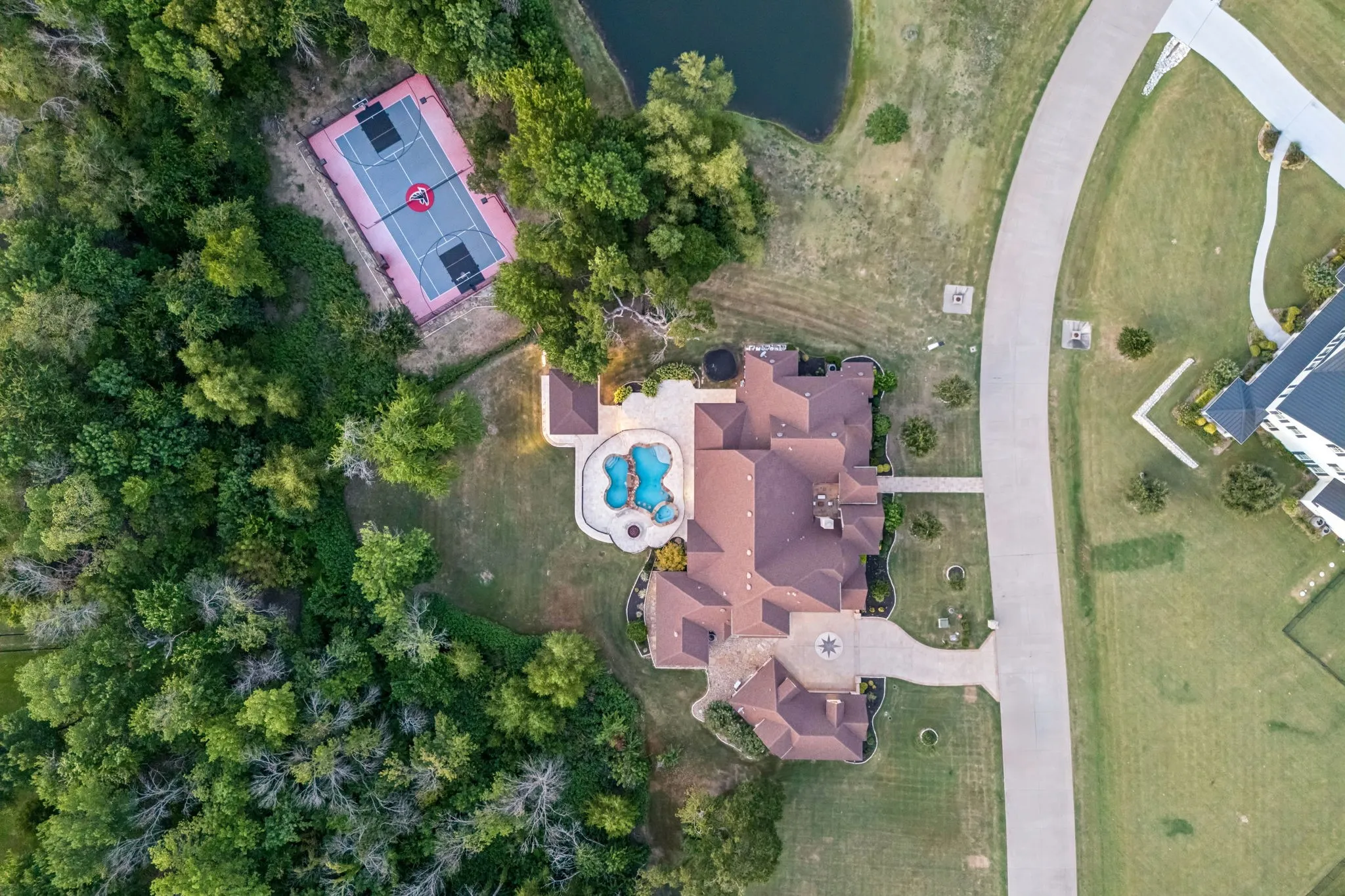 Aerial view showcasing a large residential property with an elaborate multi-gabled roofline
