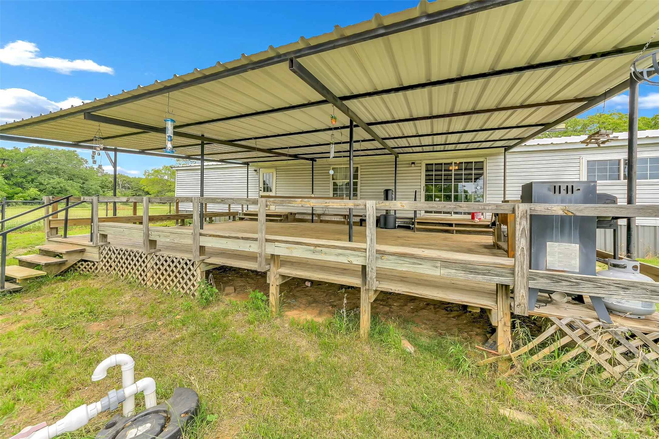 Expansive outdoor deck with a durable metal roof covering