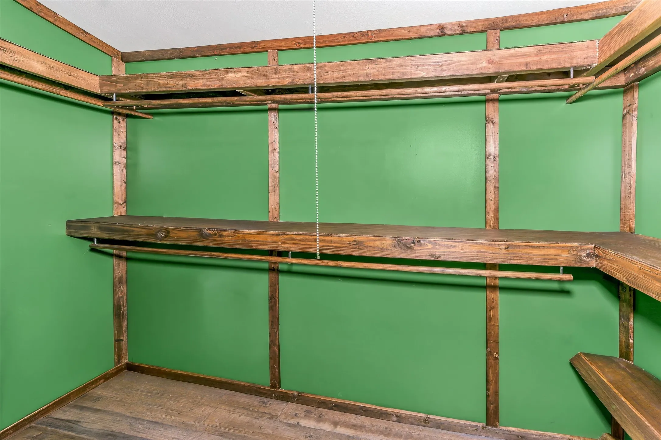 Custom-built closet system with wood-finish shelving and hanging rods