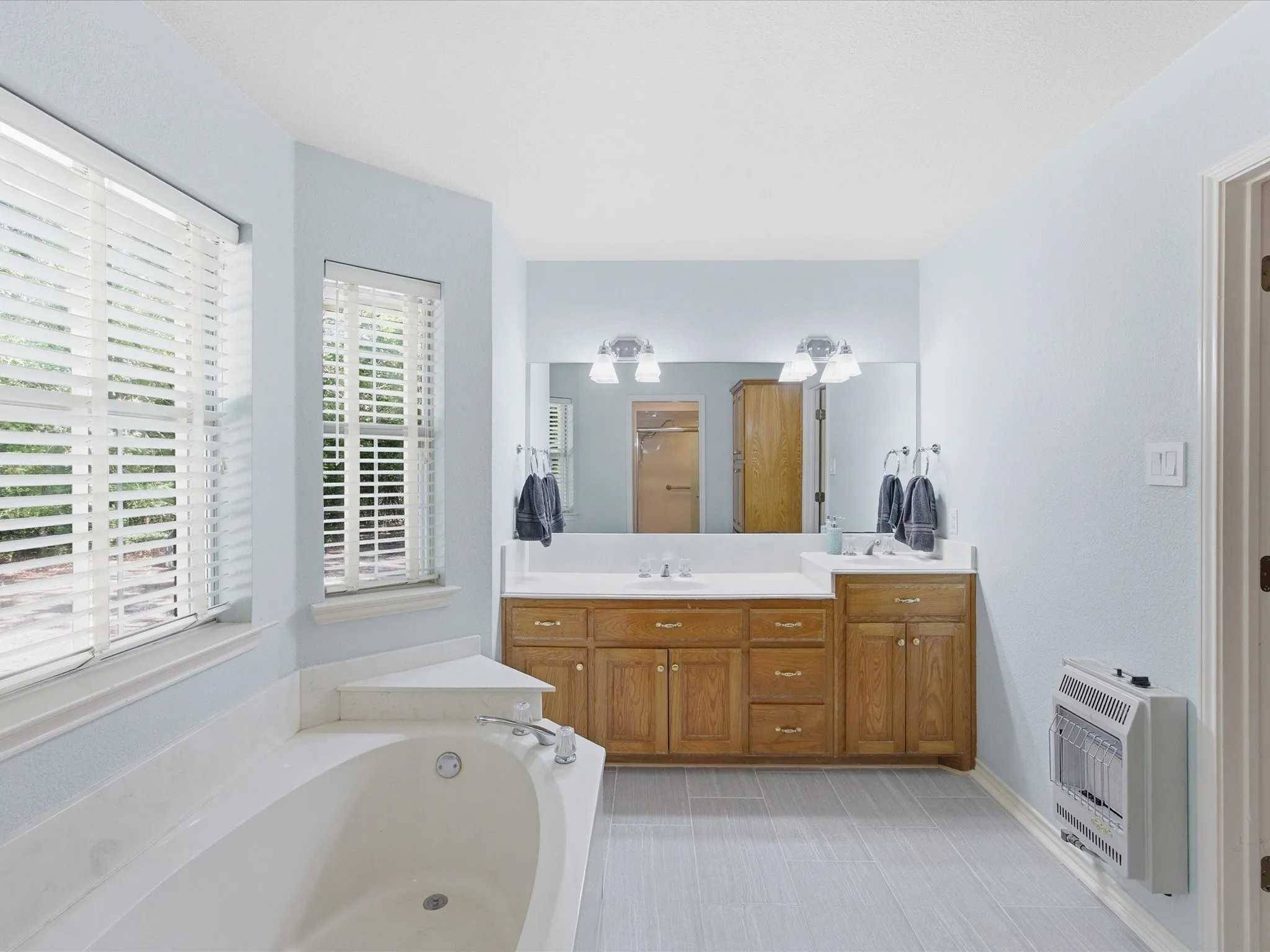 En-suite bath with garden tub, dual vanity/sinks and wall space heater