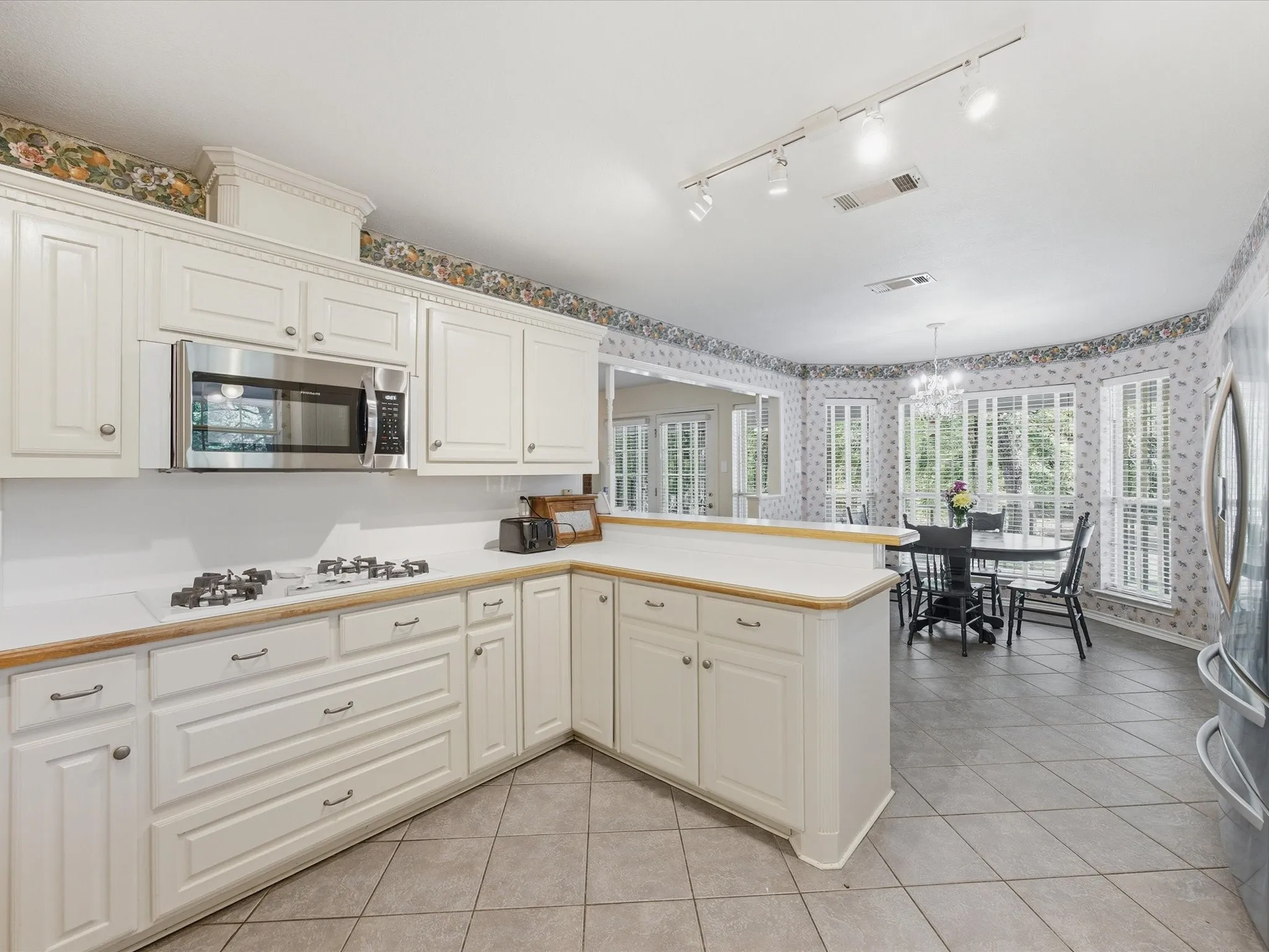 Featuring microwave and gas cooktop with vented hood