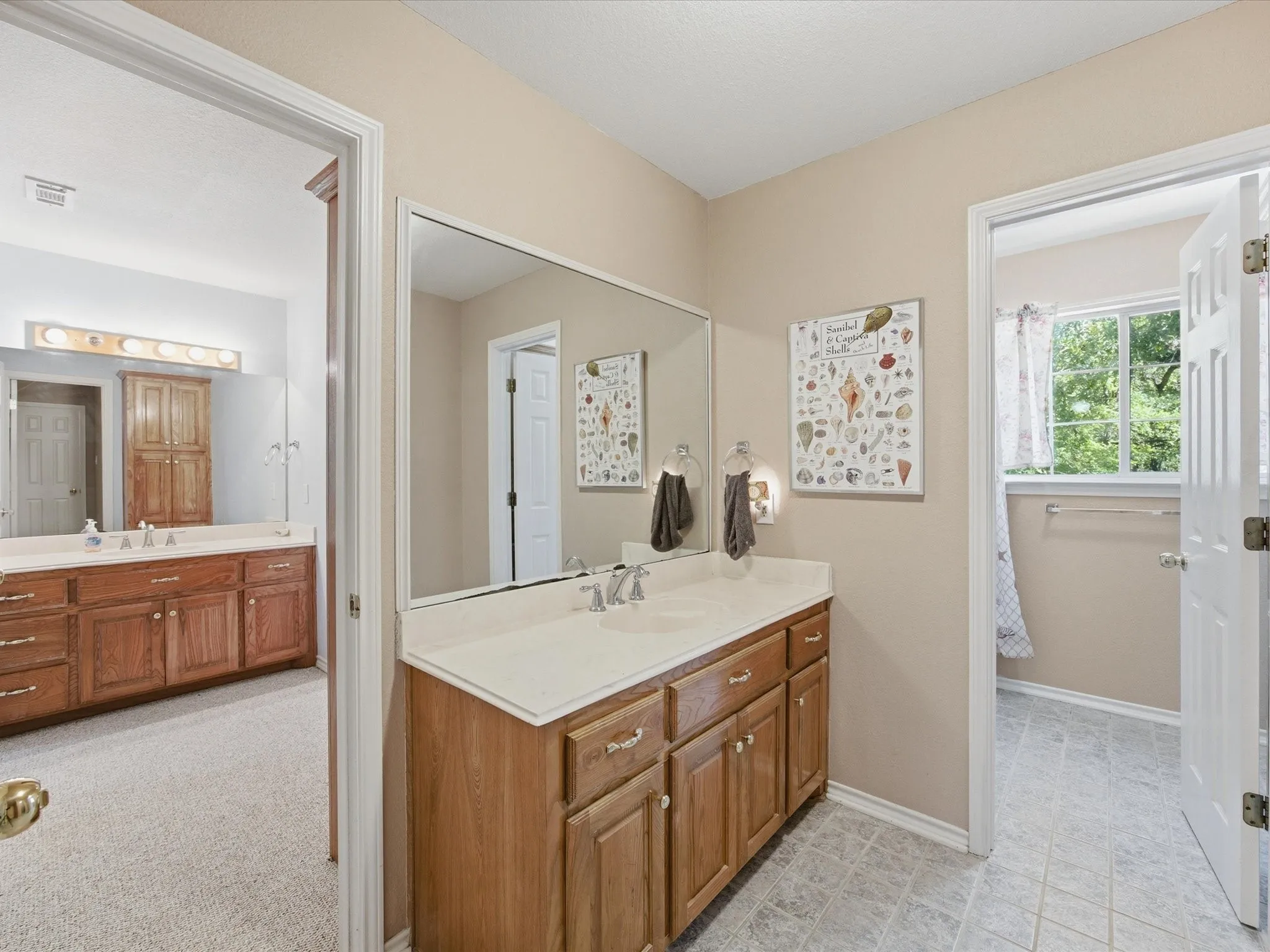 Upstairs shared Jack & Jill type bath with separate vanities/sinks and separate shower/bath and commode for optimum functionality