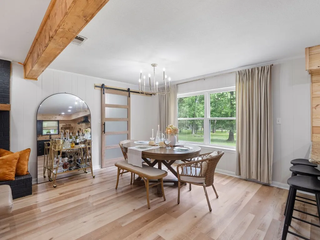 Light wood-finish flooring complements white vertical paneling