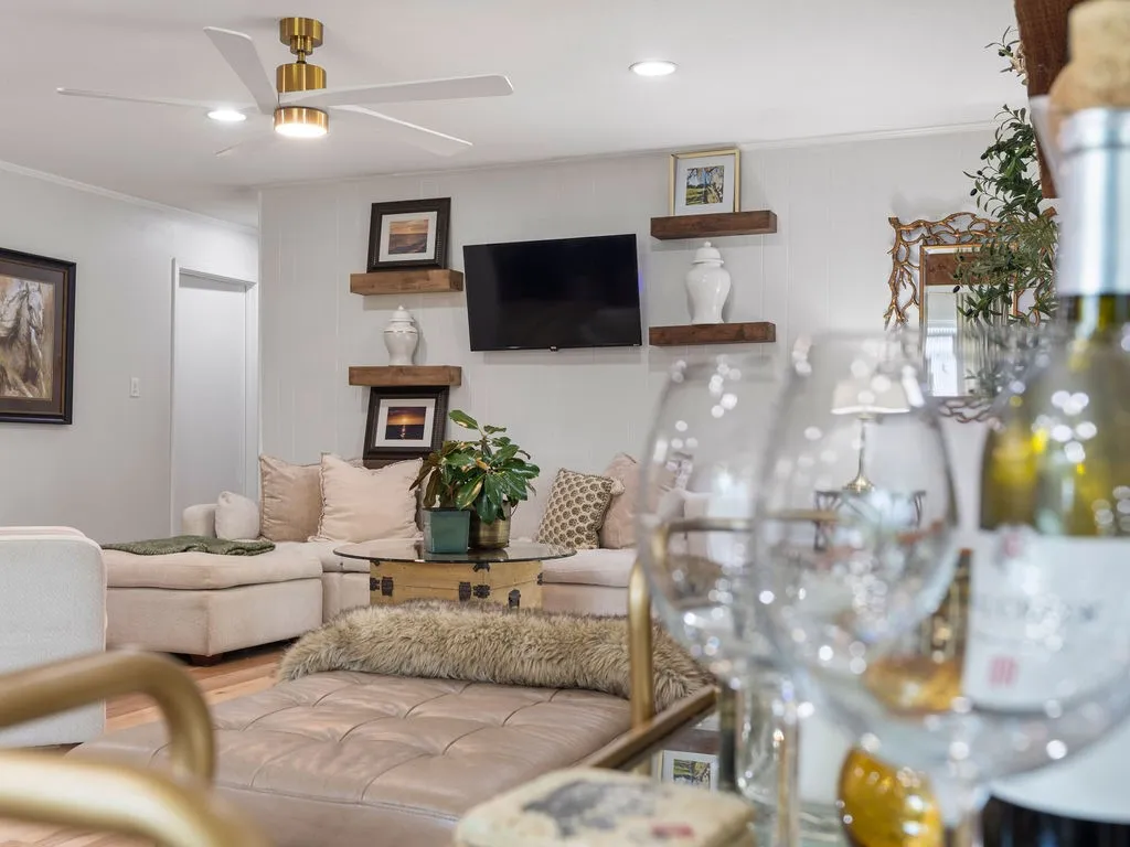 Living area featuring recessed lighting and a ceiling fan with gold-tone accents