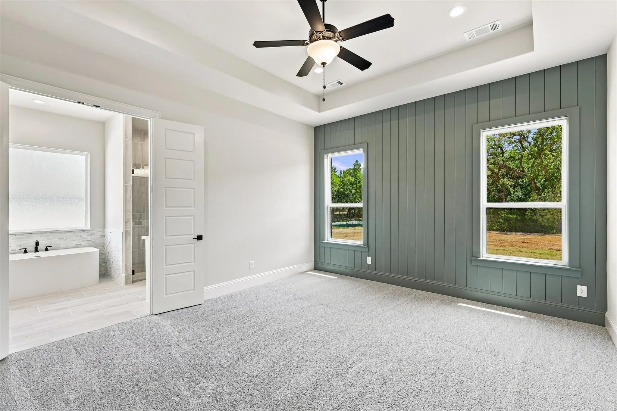 Primary Bedroom with decorative paneled wall.