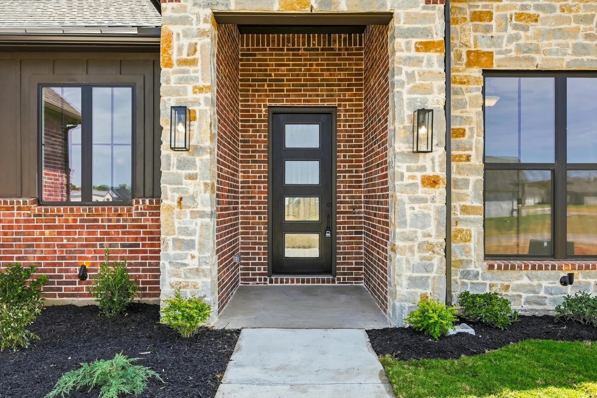Brick and stone exterior with board and batten accents