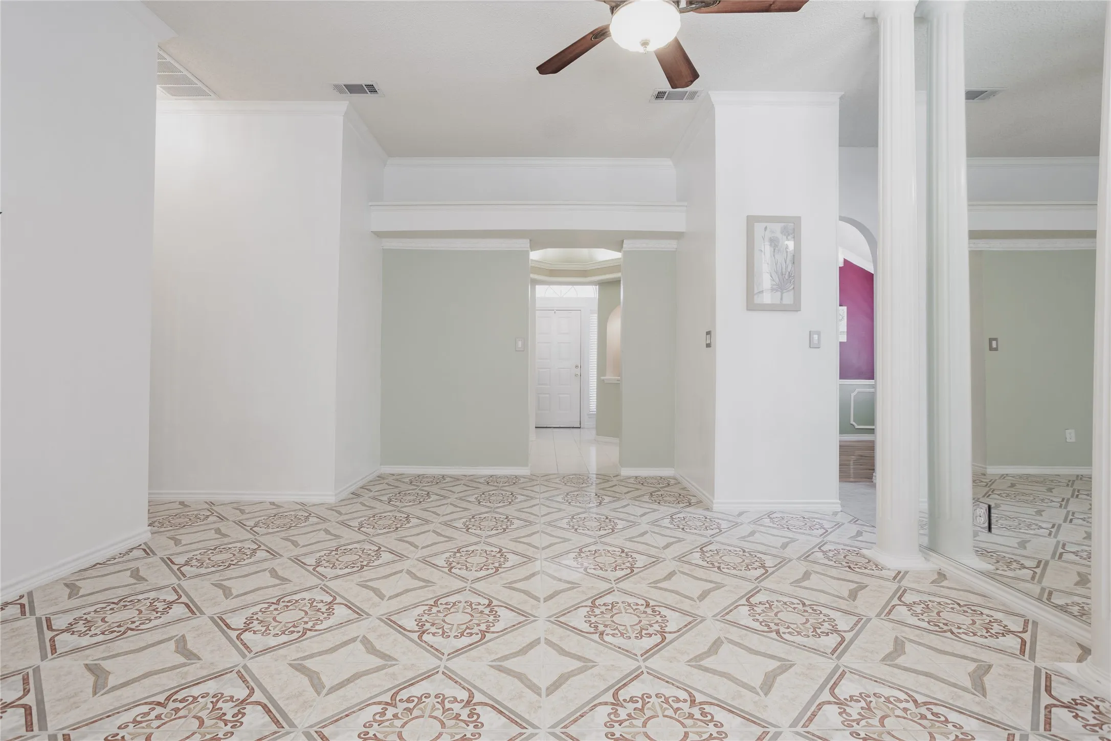 Spacious open floor plan with decorative tile flooring throughout, recessed lighting, and ceiling fan