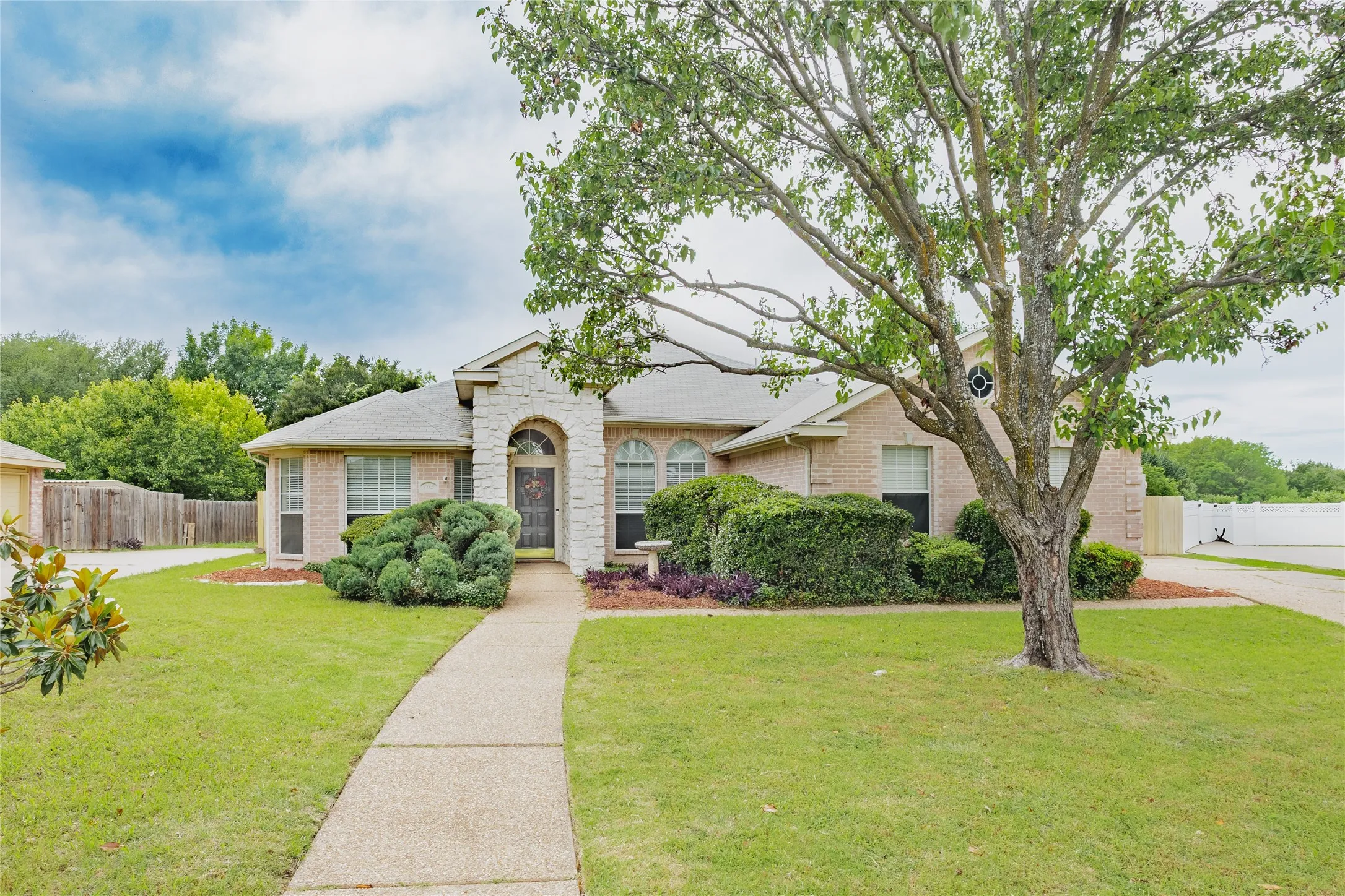 Traditional brick exterior with stone accents and a covered entry