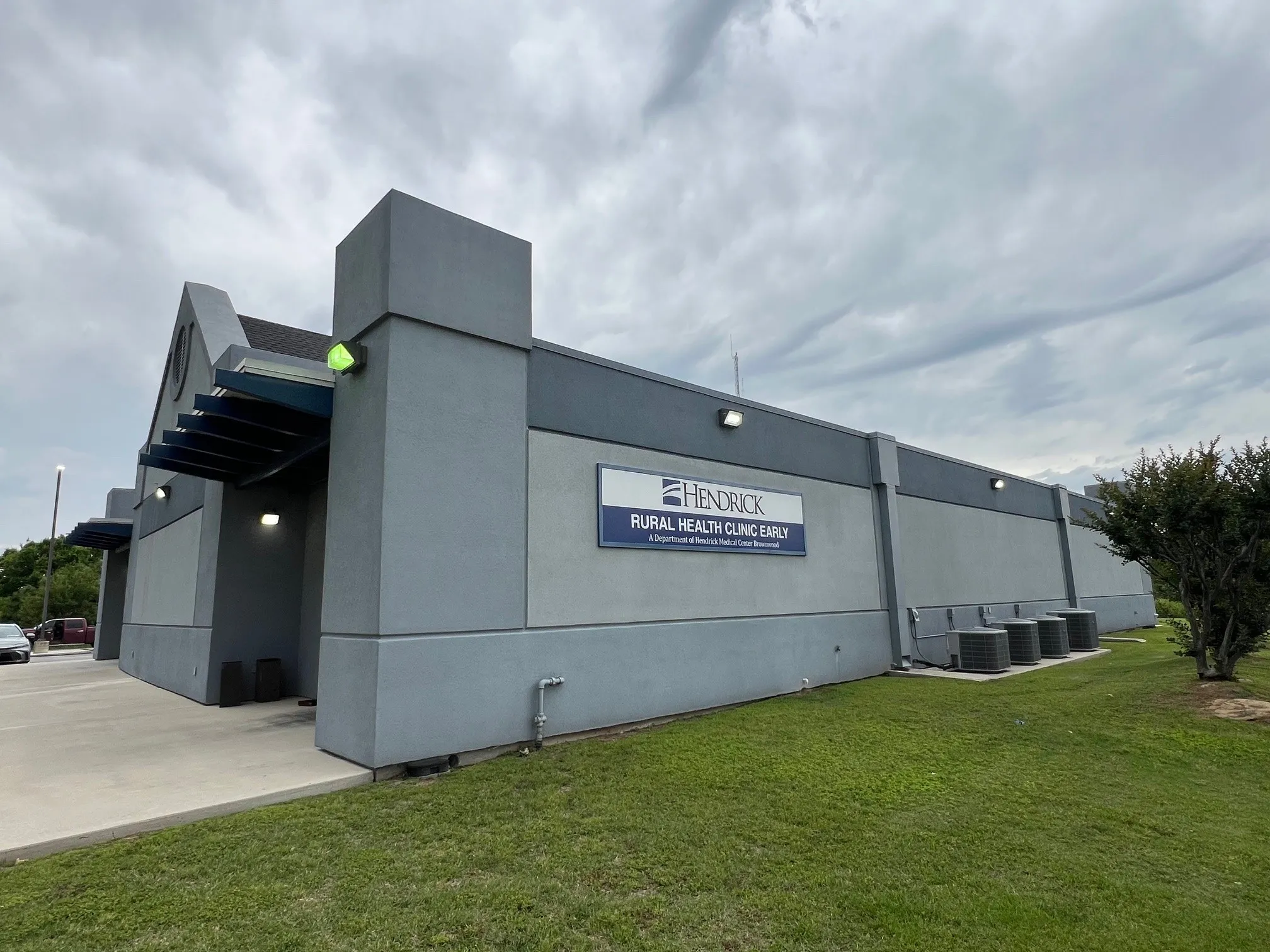 Commercial building with a gray stucco exterior and a dark gray roofline