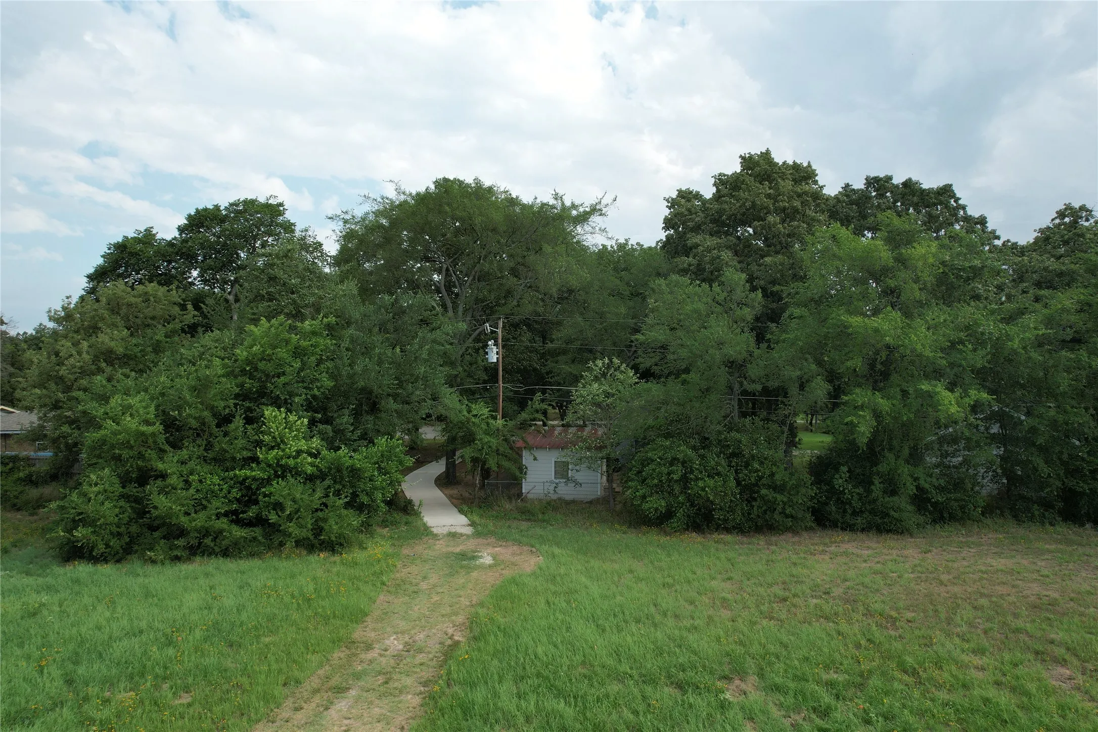 The mowed maintained walking path from the concrete path access in Cedar Crest Shores, 135 Hilltop Drive neighborhood