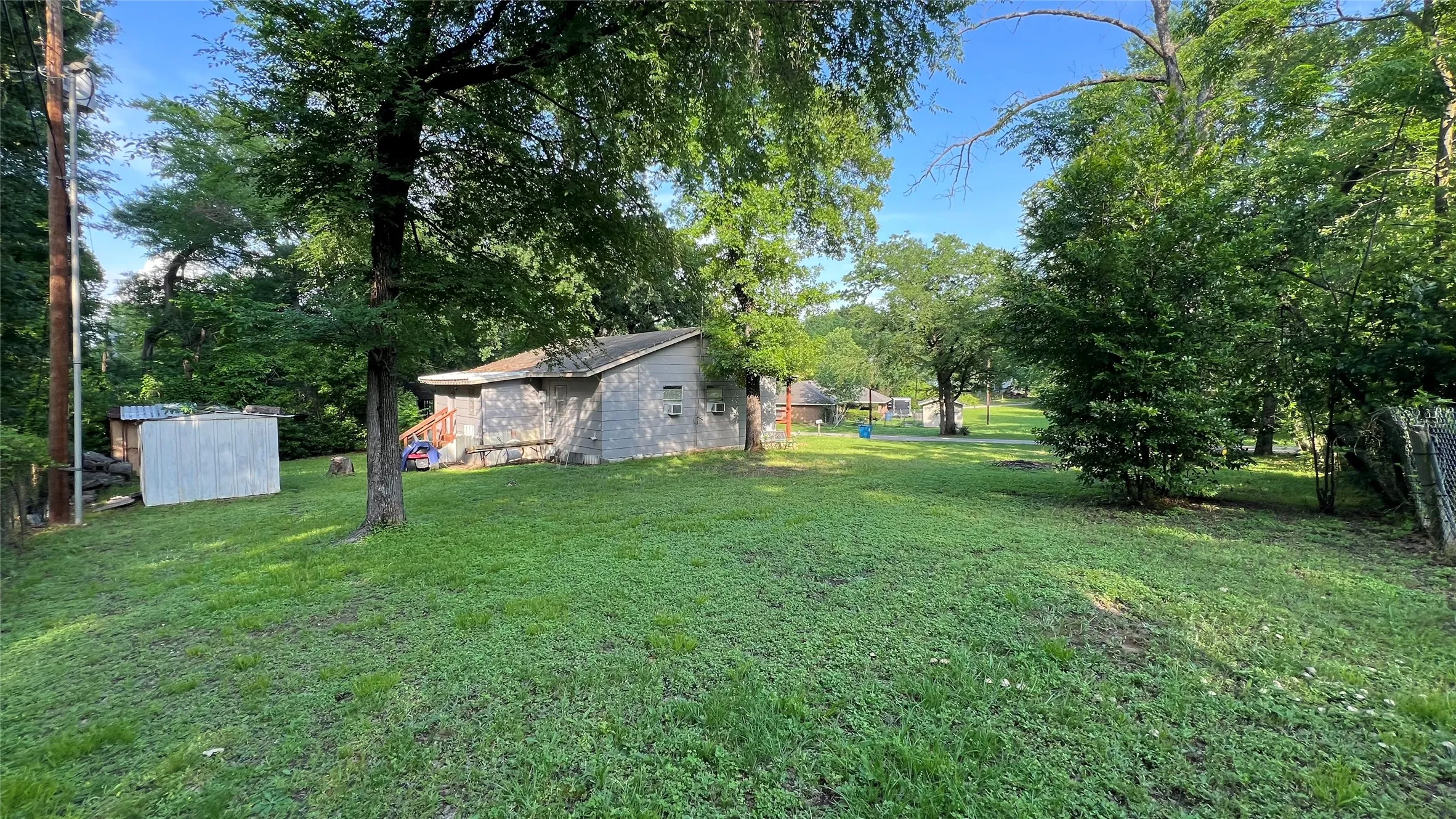 Picture taken from the back corner of the extra lot showing all of the land selling with the house