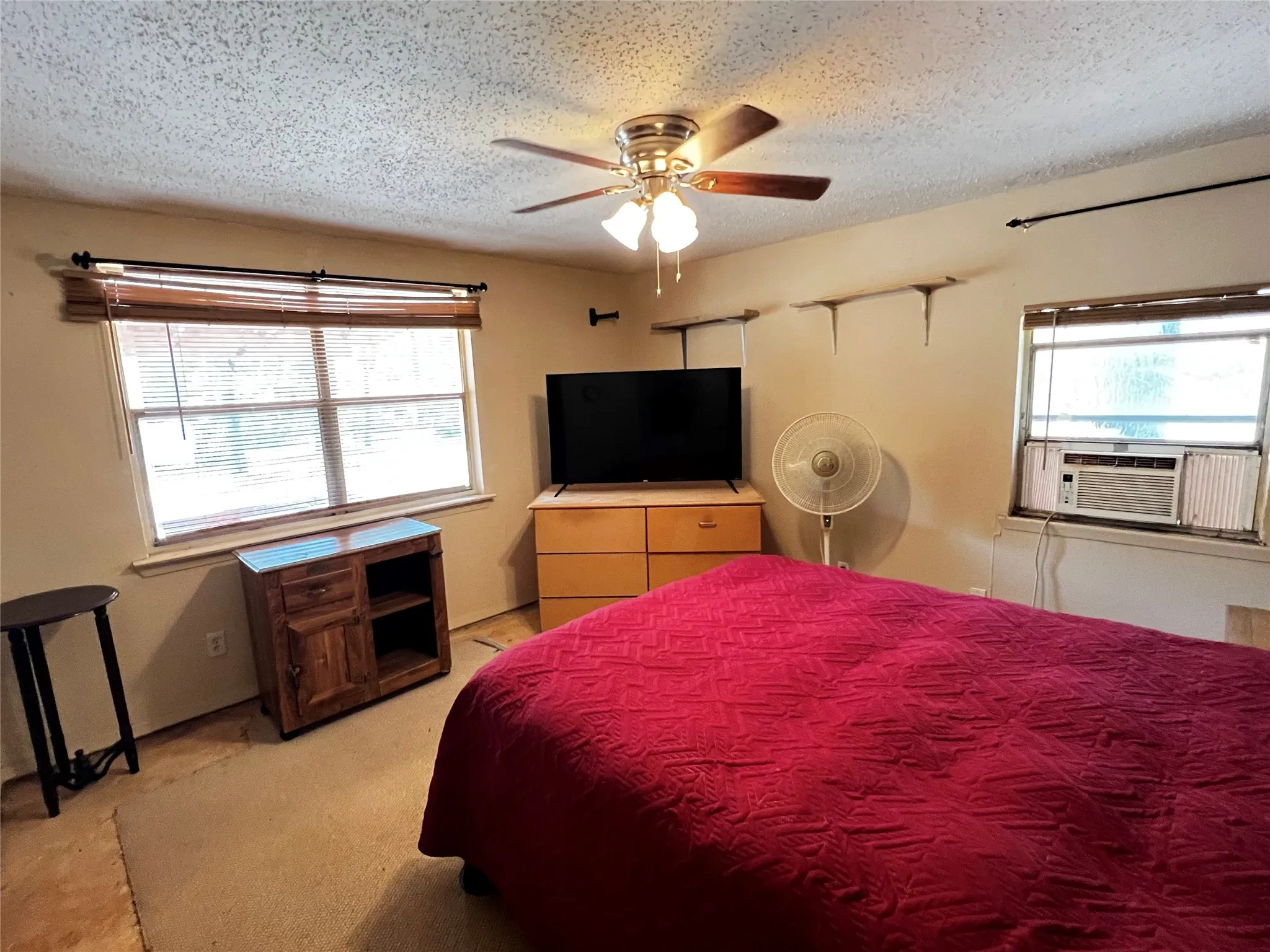 Front Bedroom with horizontal blinds, a ceiling fan with light fixture, windows on two walls for natural light