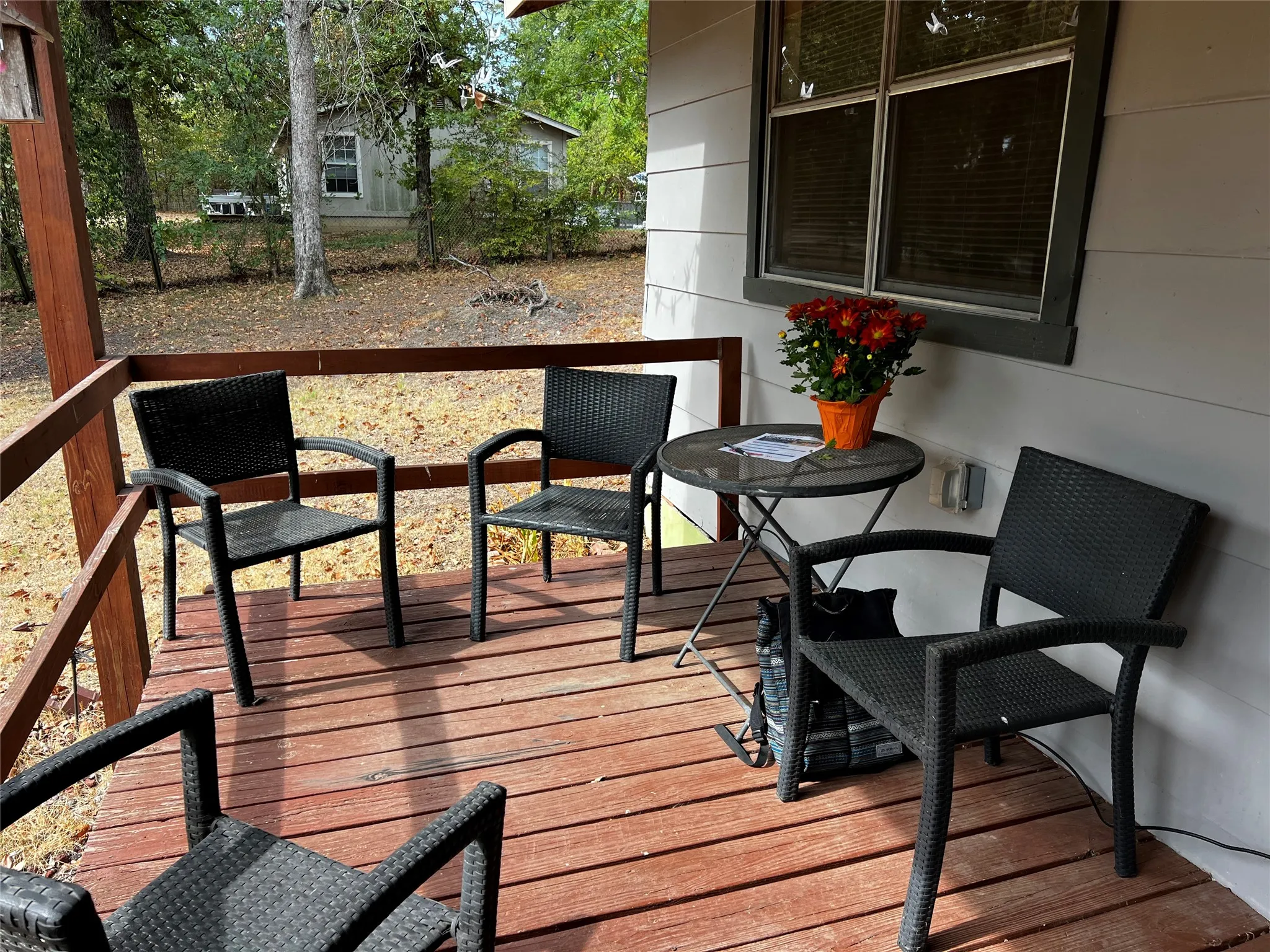 Spacious front covered porch deck with a wood railing.