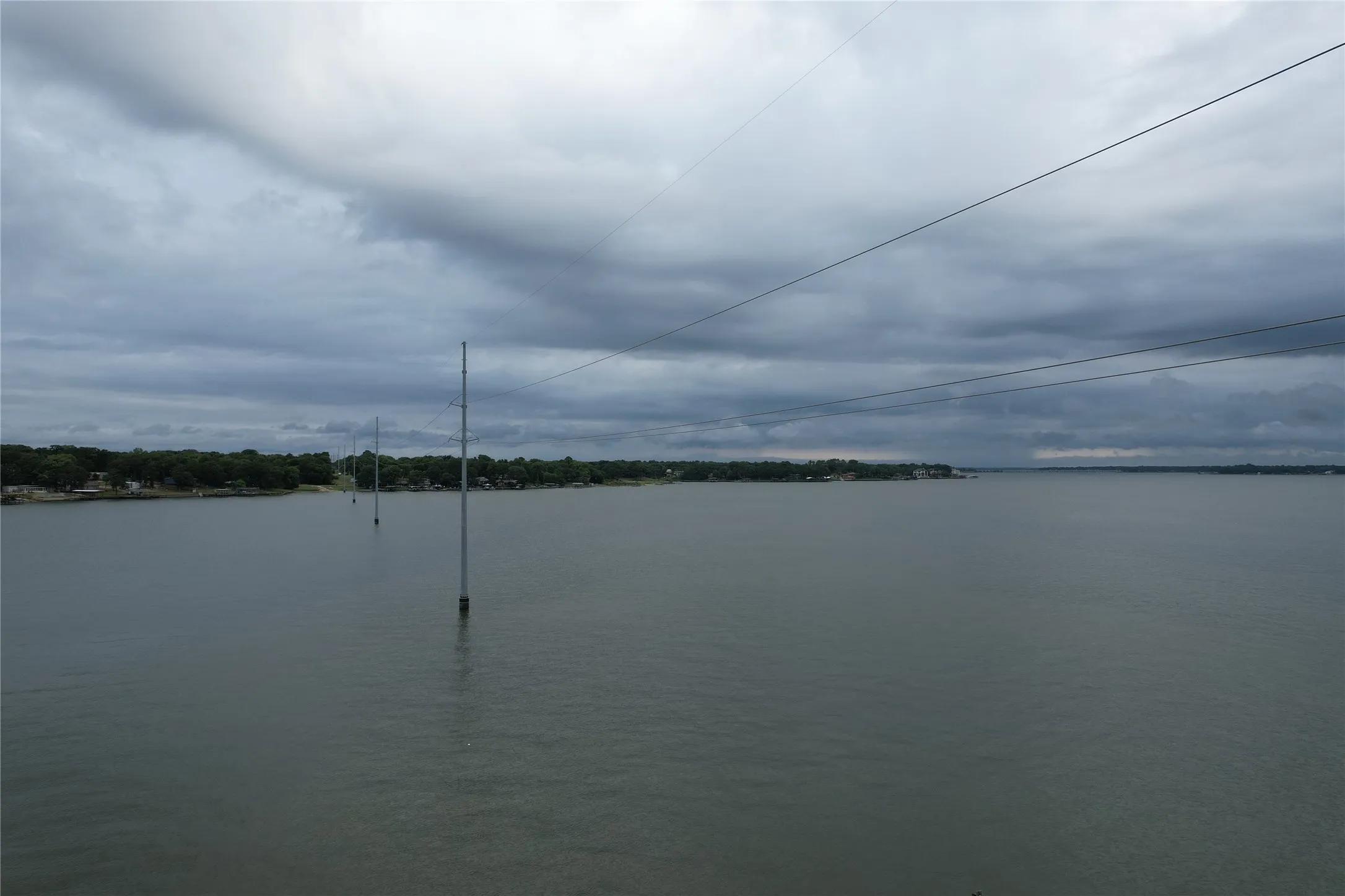 View from the Cedar Crest Shores neighborhood Park with a large pier, boat ramp, lake access, and picnic area