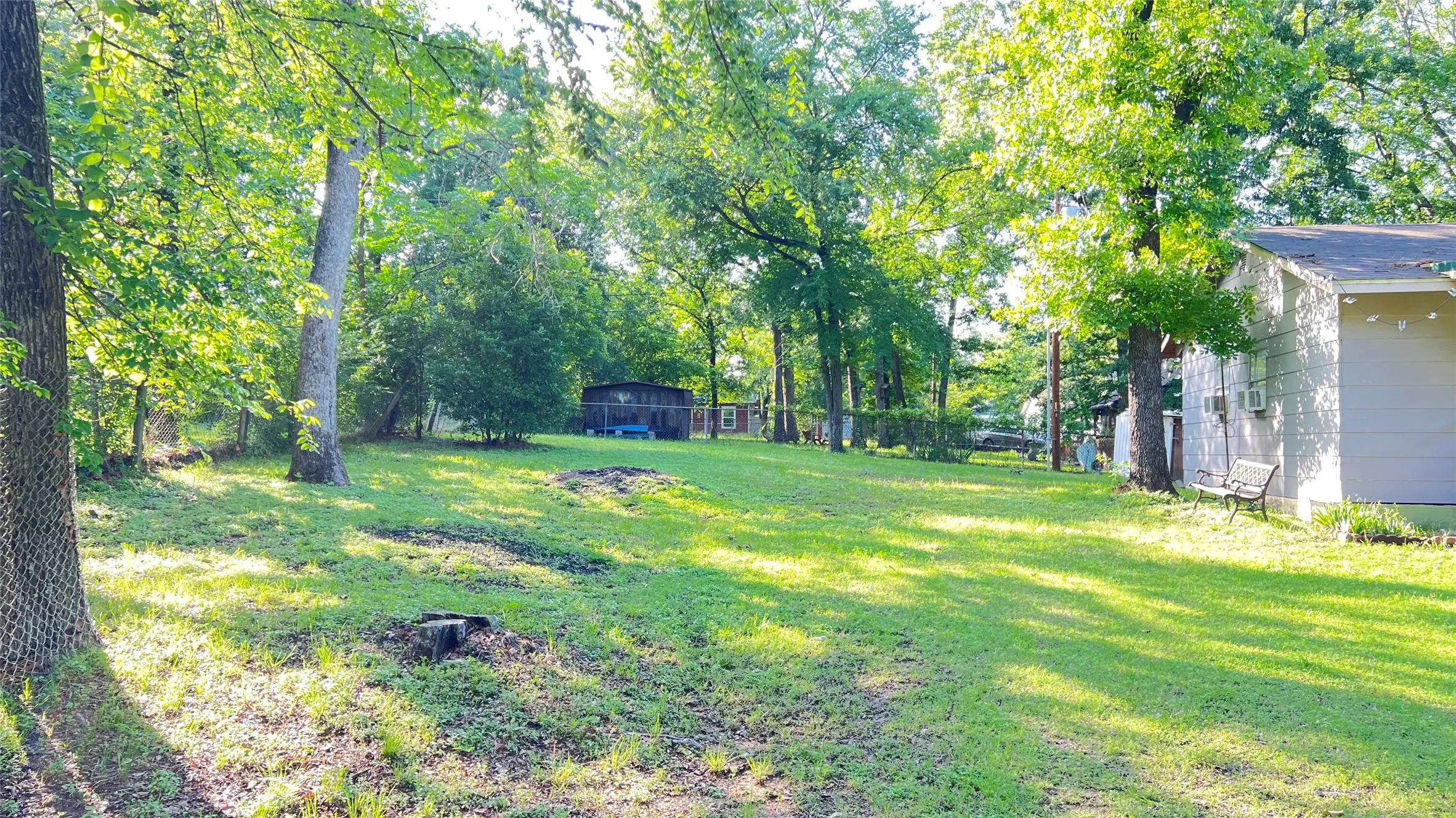 View from street of the extra lot that is selling with the house.   This provides extra space for more private setting, or an opportunity for house expansion, or build another home, or sell it to off.