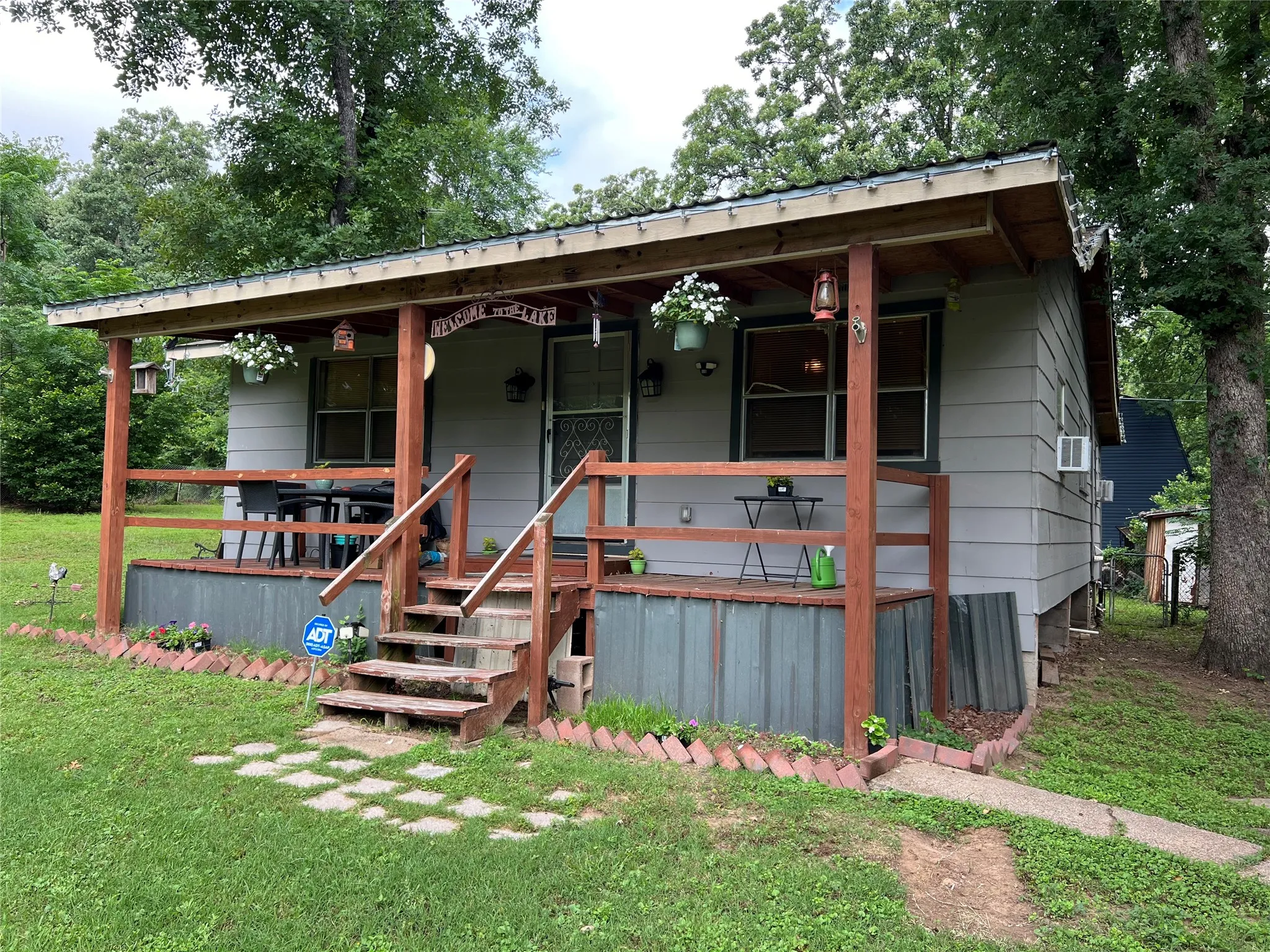 Covered front porch with wood-tone posts and railings
