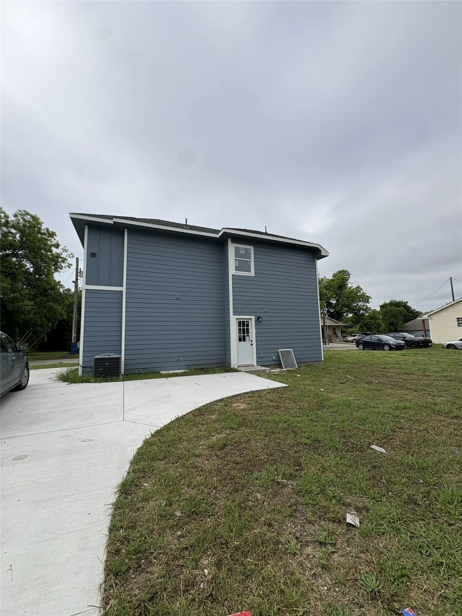 Two-story exterior with blue horizontal siding and white trim