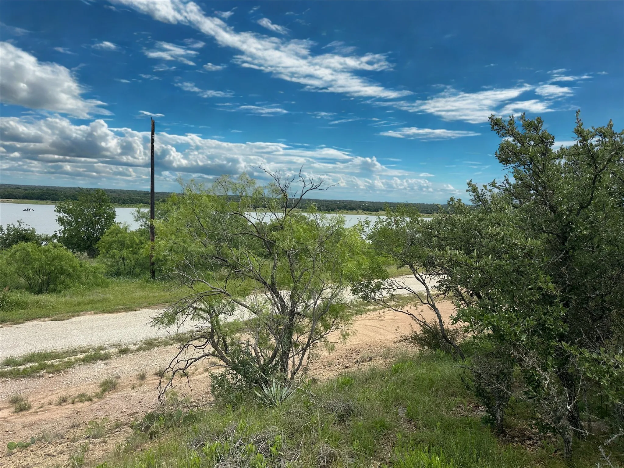 Expansive water frontage with mature trees and natural landscaping