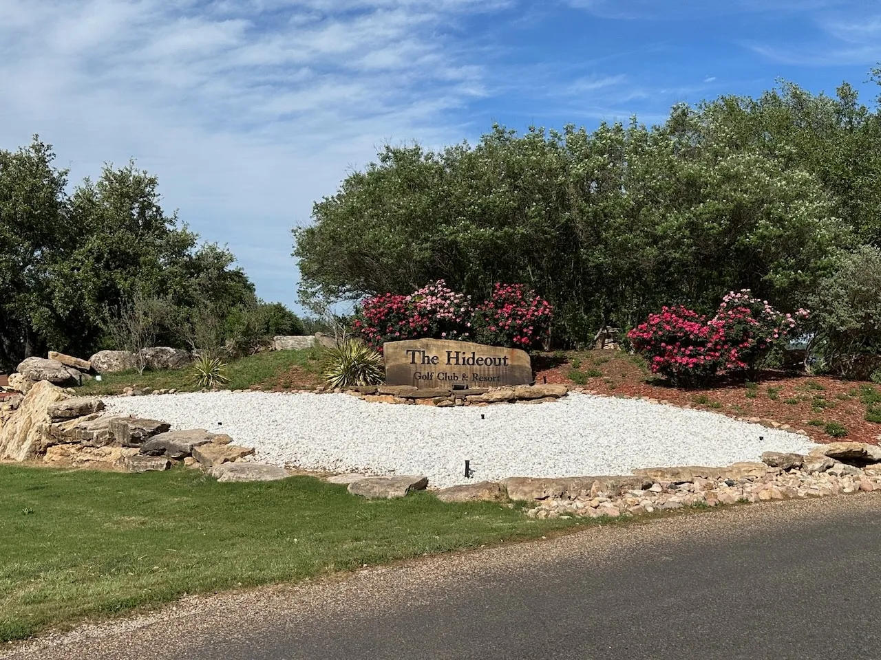 Stone entrance monument featuring "The Hideout Golf Club & Resort" inscription