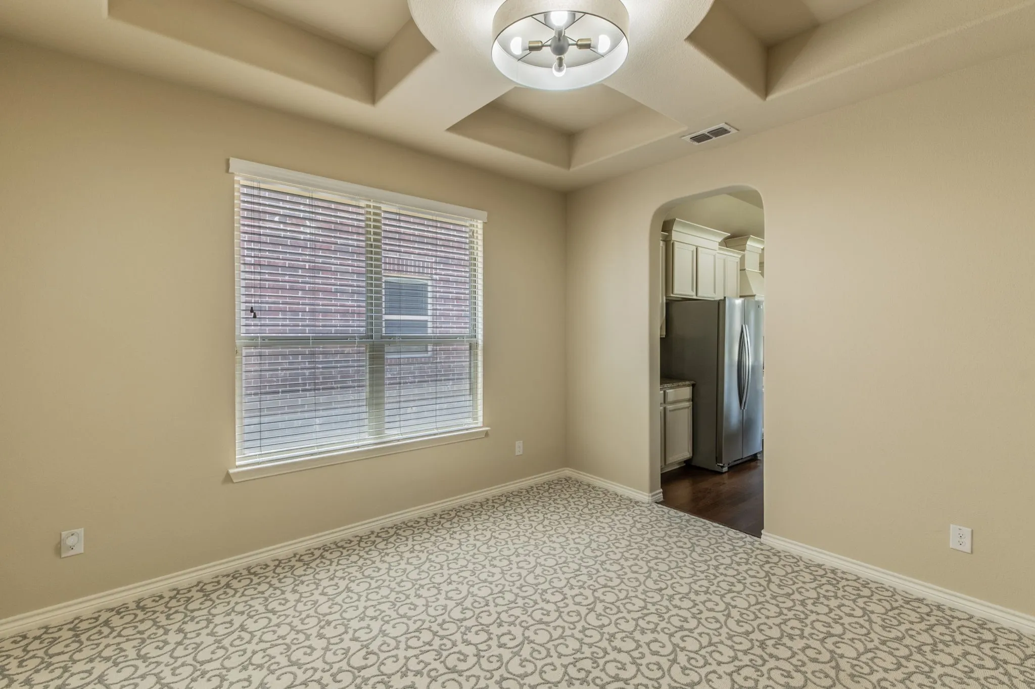 Formal dinning room with architectural coffered ceiling