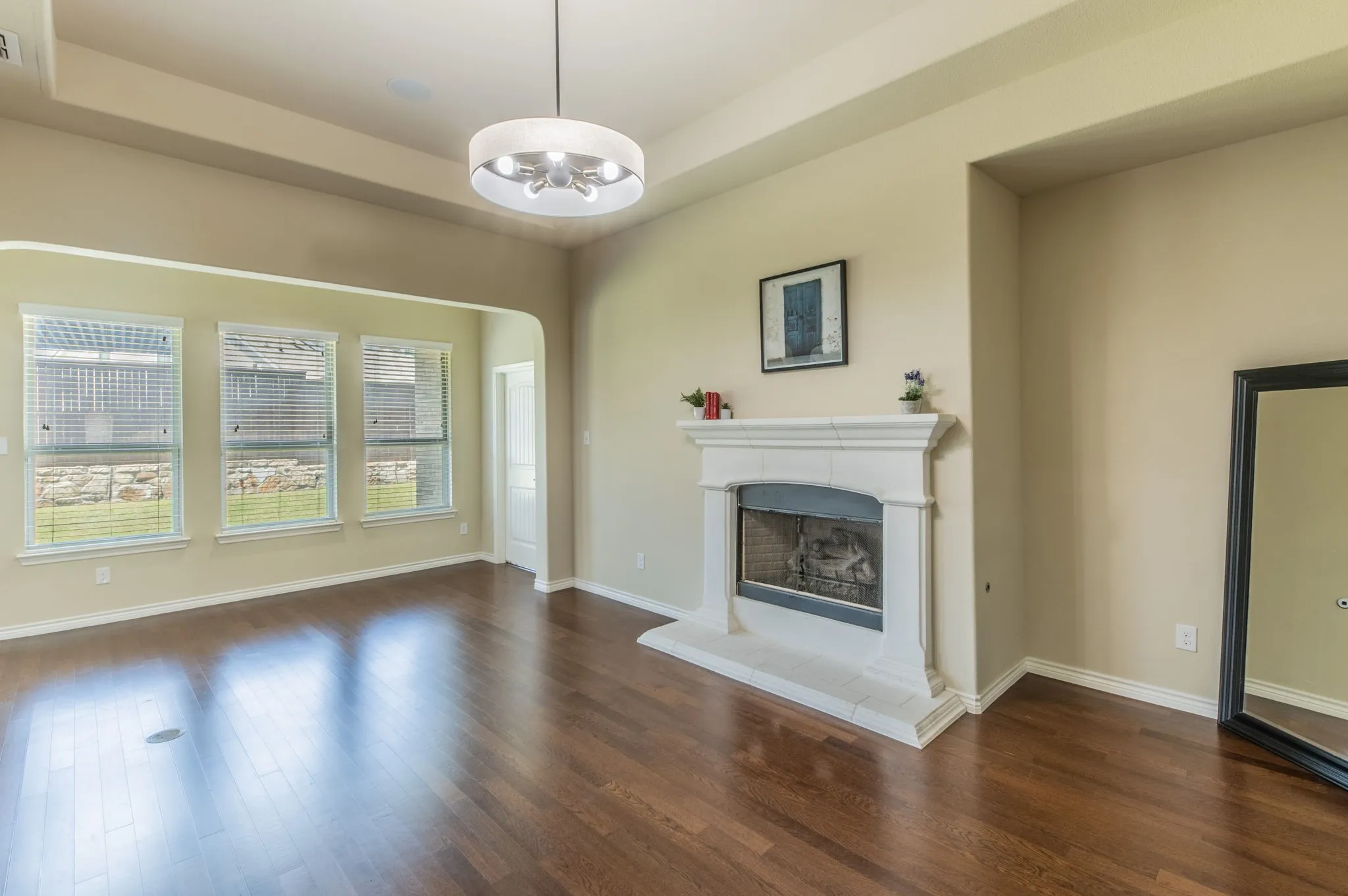 Living Room with gas fireplace and wall of windows & architectural coffered ceiling