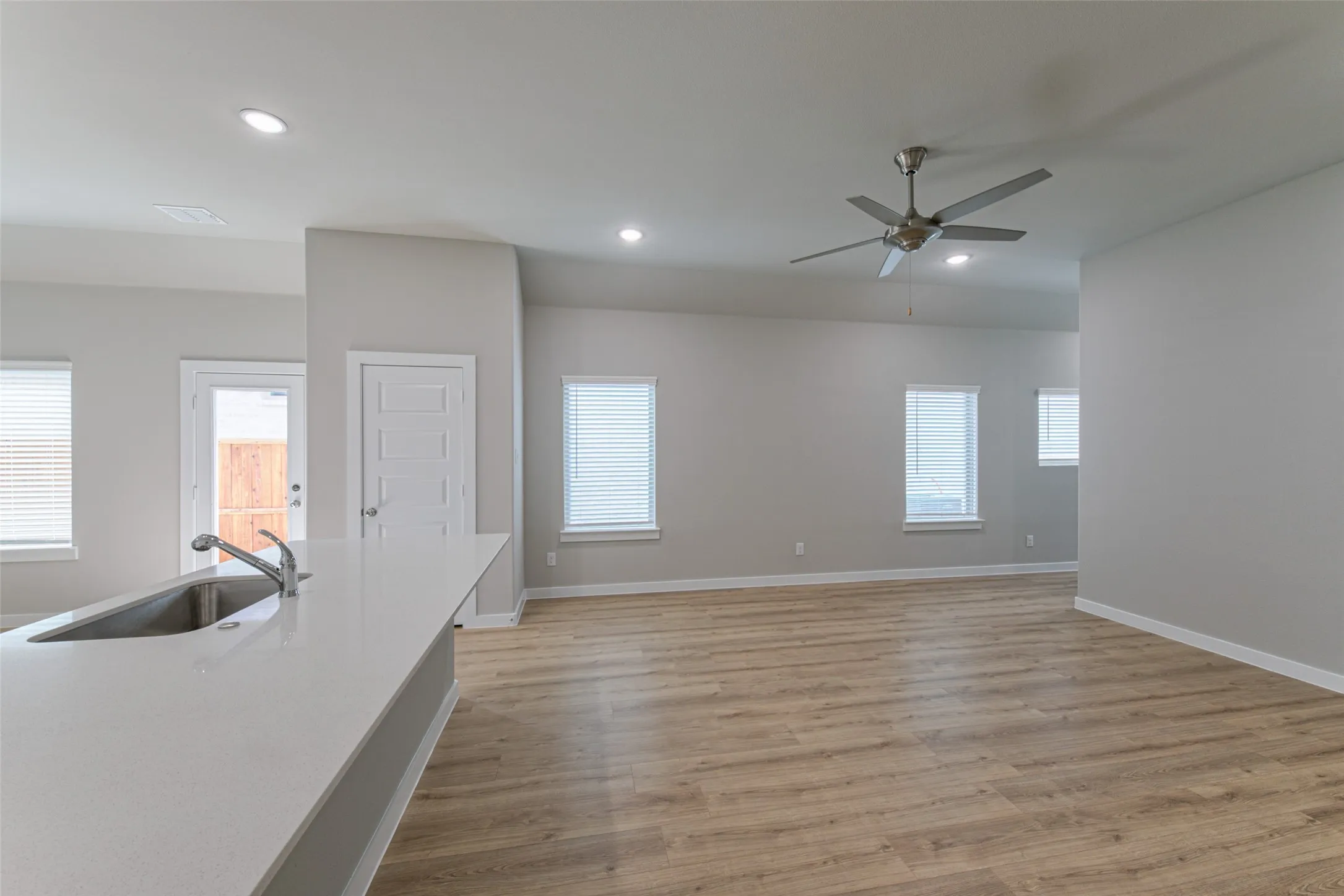 Kitchen island with a stainless steel sink and a gooseneck faucet