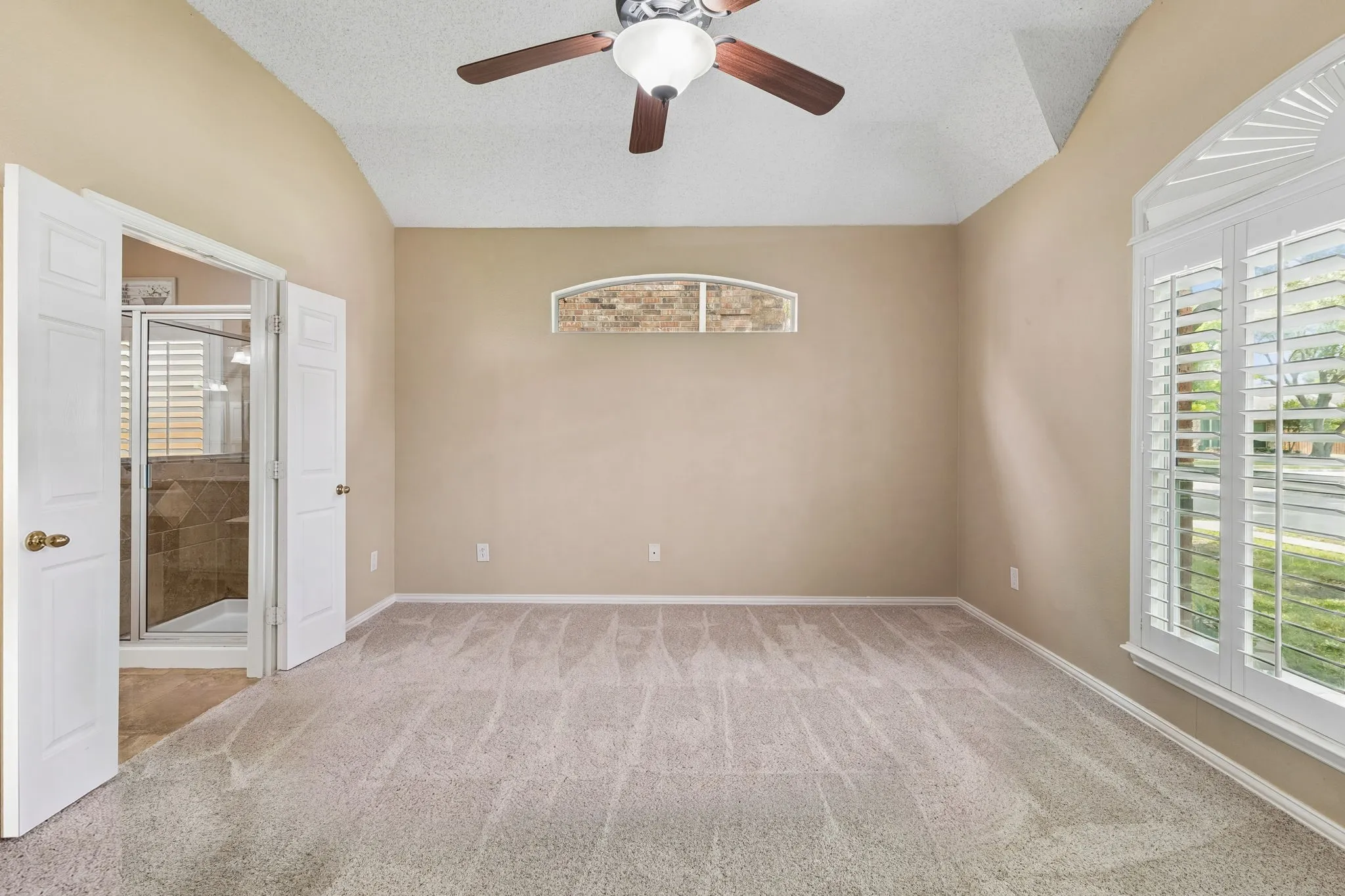 Spacious primary retreat, on the first floor, has great natural light, plantation shutters and large en suite bathroom.