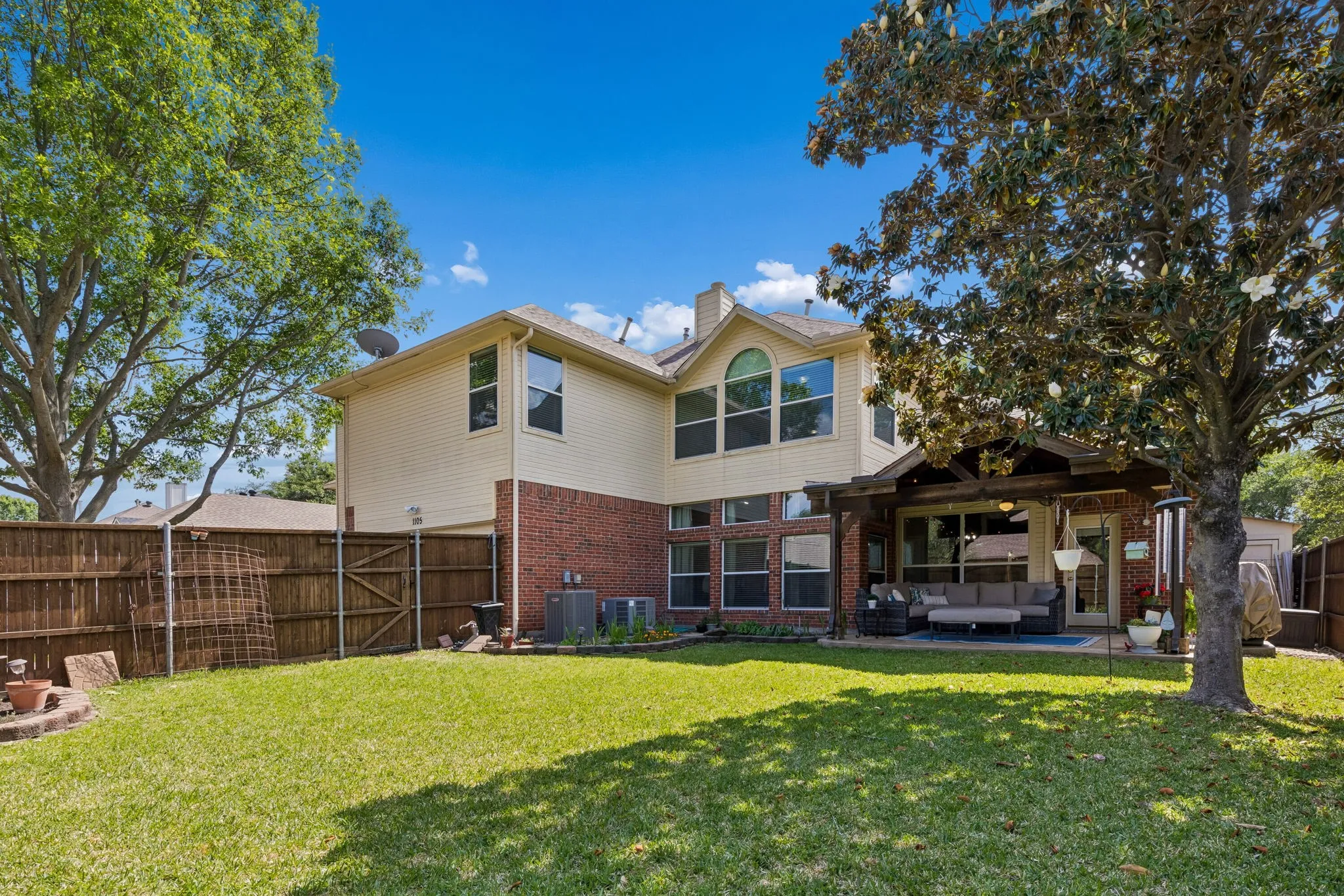 View of the back of the home. Notice there is an attached shed for yard implements on the side of the home.