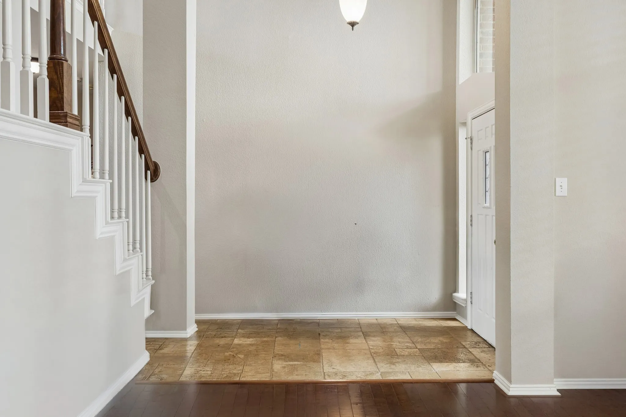 Looking from the living room into the spacious entry. The open and airy feel of the space is enhanced by the massive 2nd story window overlooking the entry.