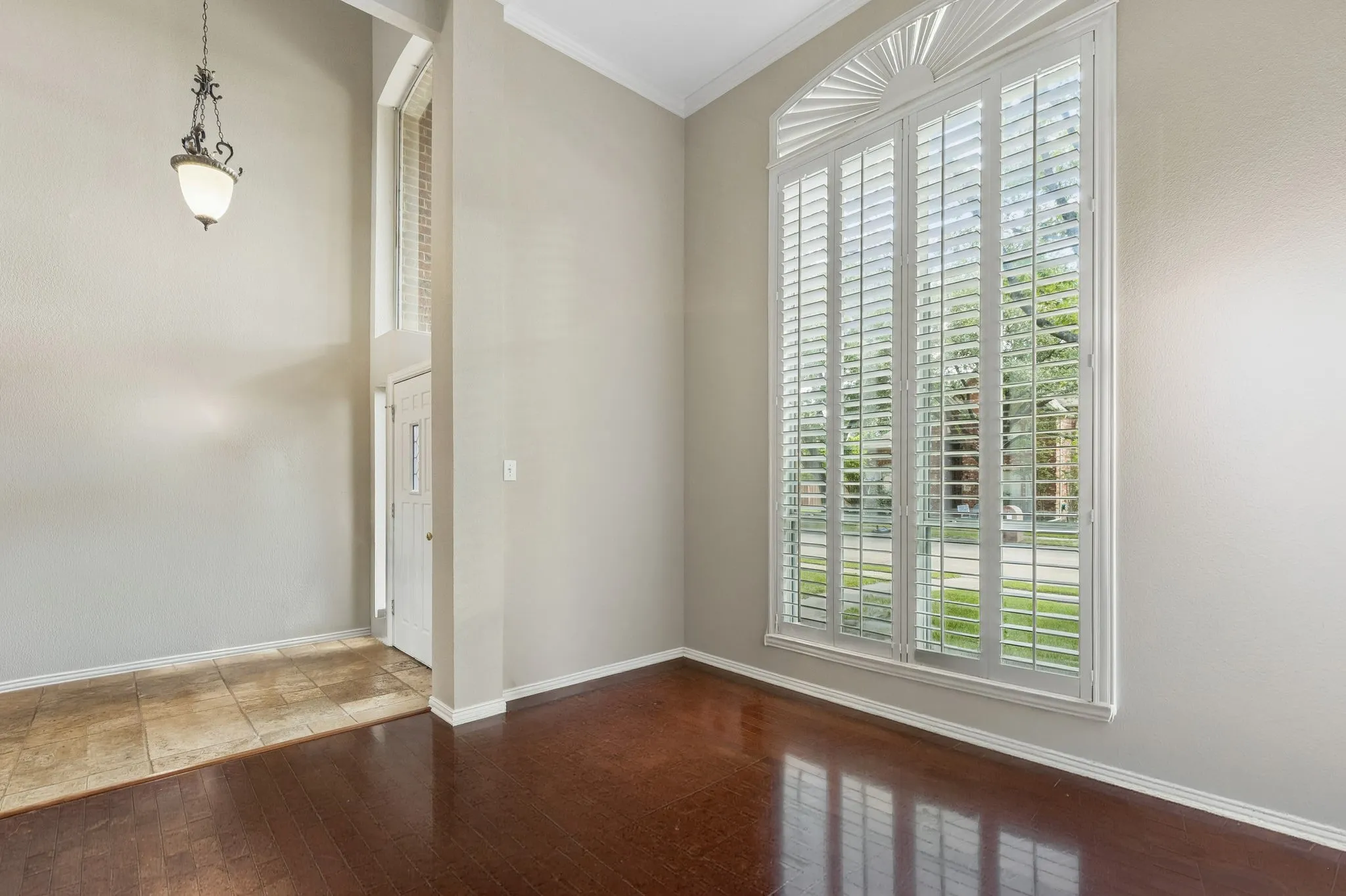 This view of the living room highlights the lovely crown moulding and the wonderful natural light the space enjoys.