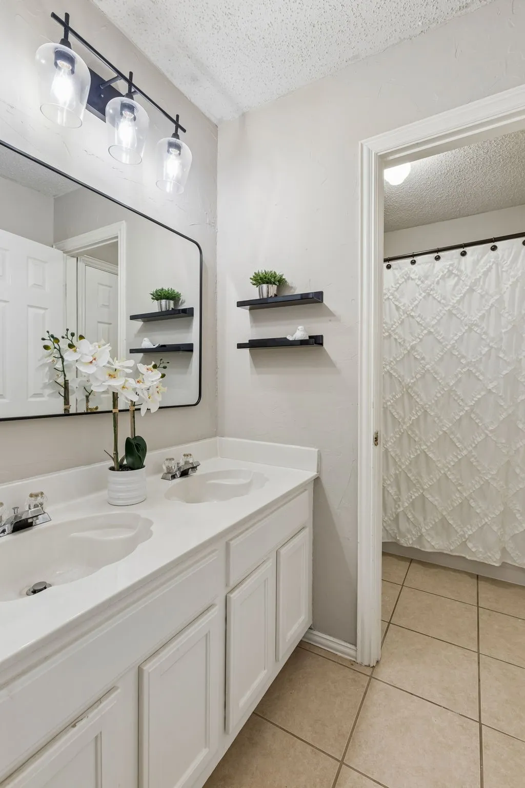 Second story hall bath has dual vanity and a separate room for the shower/tub combo and the water closet for added privacy.