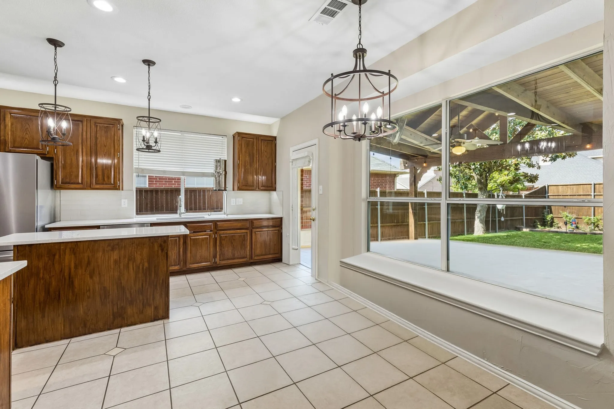 The nook overlooks the outdoor living space and beautiful backyard.