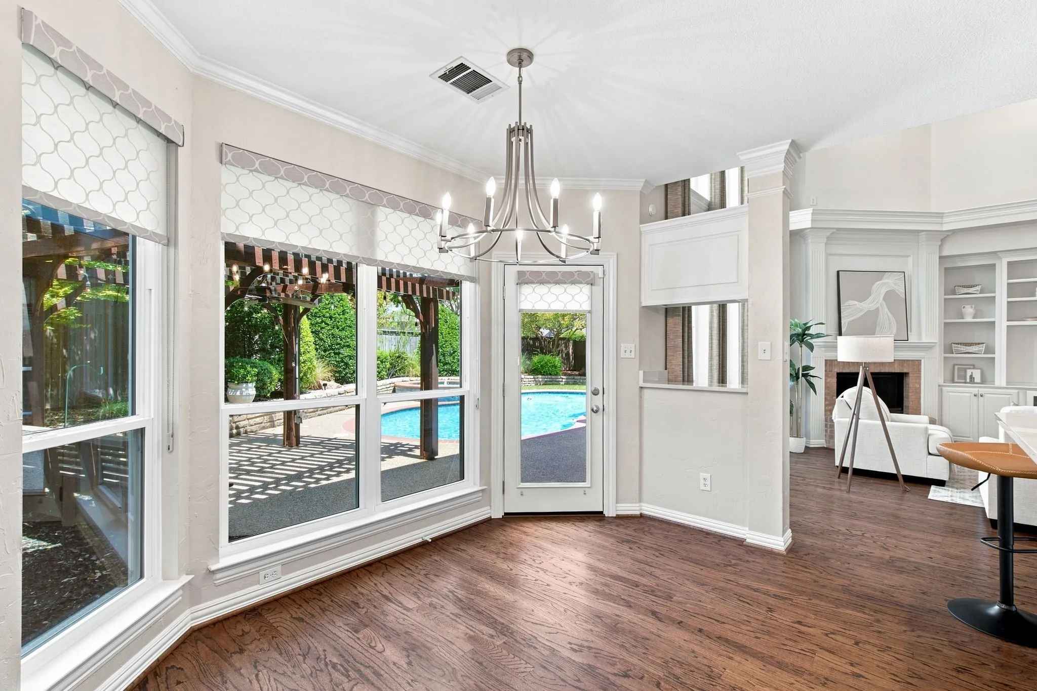 Wood-finish flooring with an adjacent outdoor pool