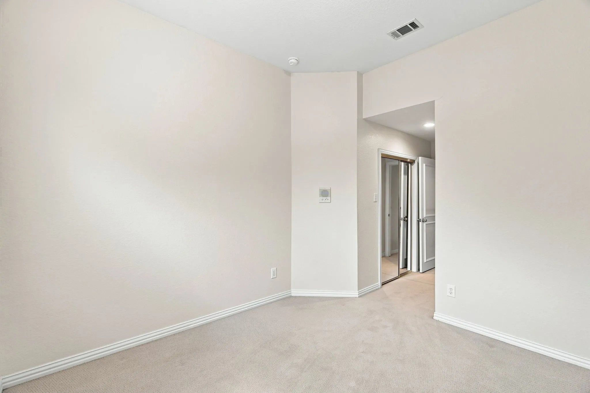 Plush carpet flooring, neutral wall paint, and white trim