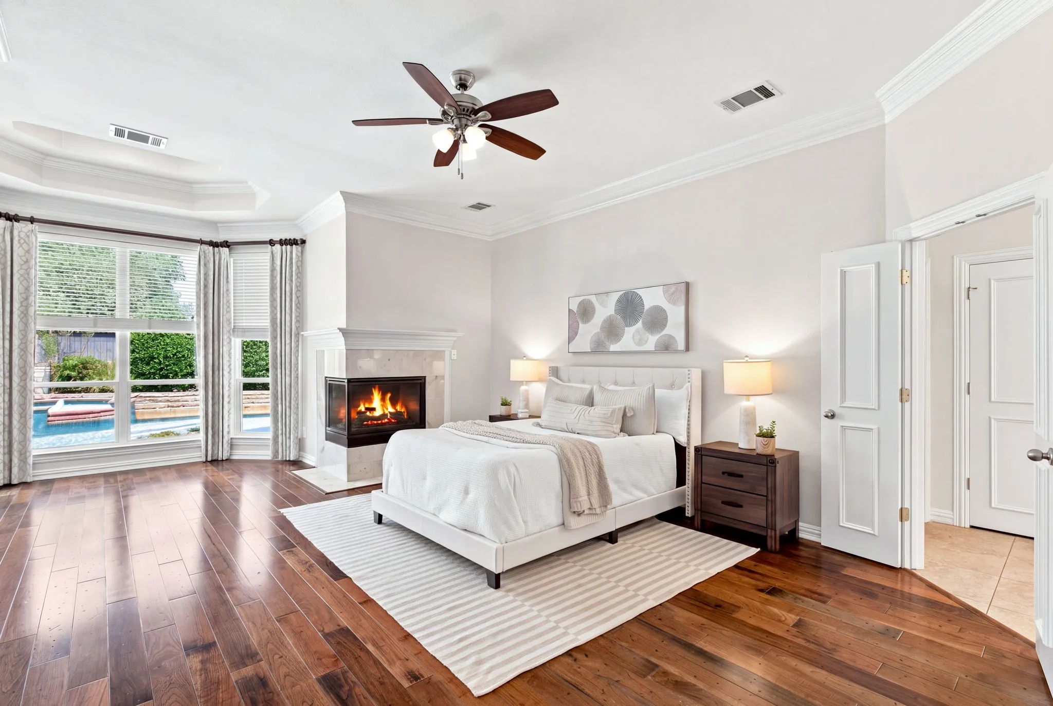 Hardwood-finish flooring throughout, a tray ceiling, and crown molding accents