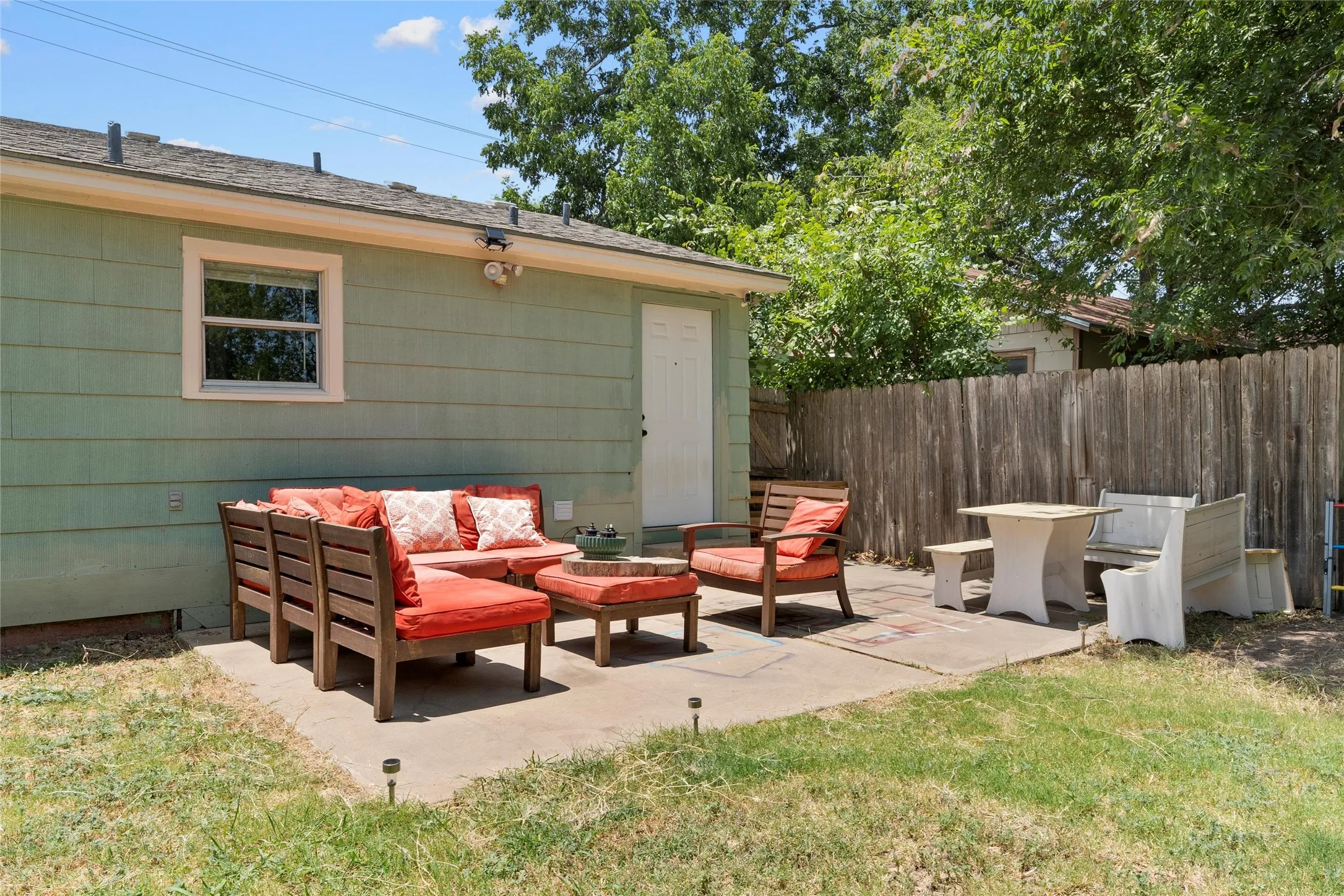 Concrete patio area featuring a light green exterior​​‌​​​​‌​​‌‌​‌‌​​​‌‌​‌​‌​‌​​​‌​​ wall