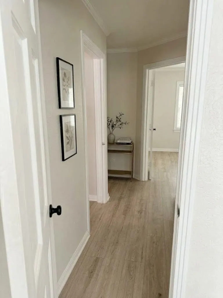 Light wood-finish flooring extending through the hallway