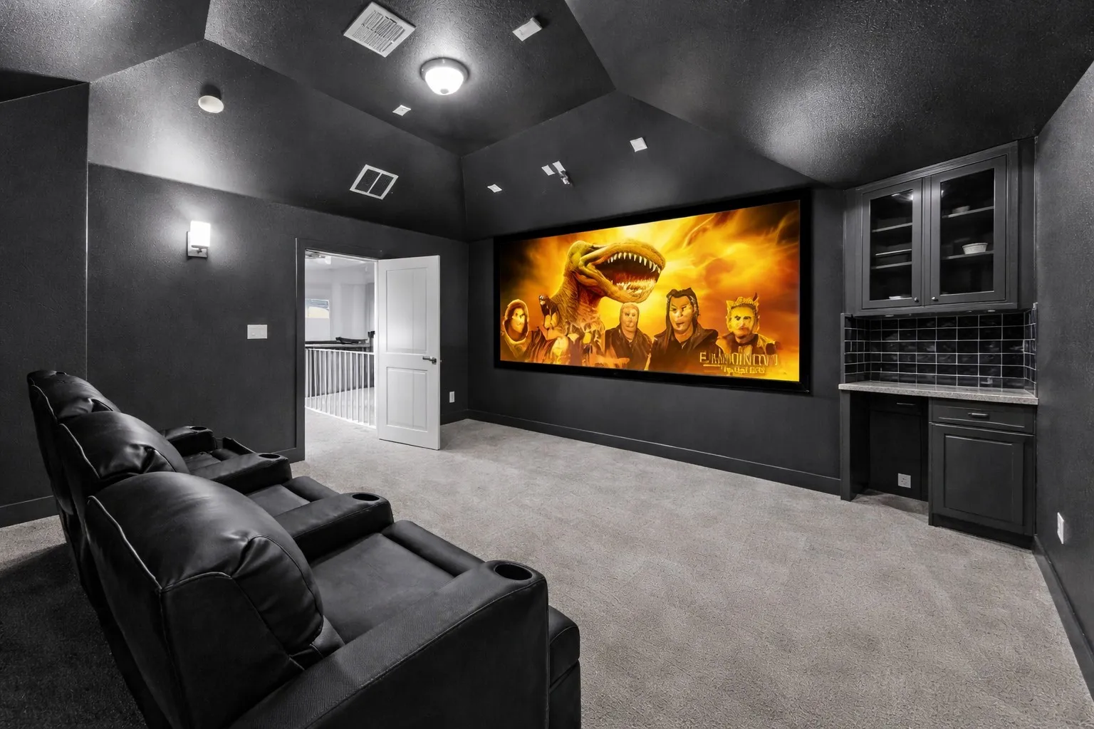 Dedicated media room featuring a large projection screen, dark wall finishes, and recessed ceiling lighting
