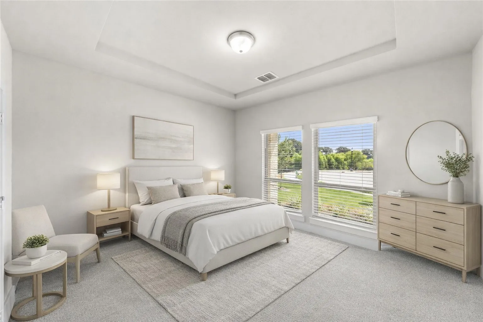 Spacious bedroom featuring a recessed ceiling, two large windows with blinds, light-toned carpeting, and a ceiling-mounted light fixture