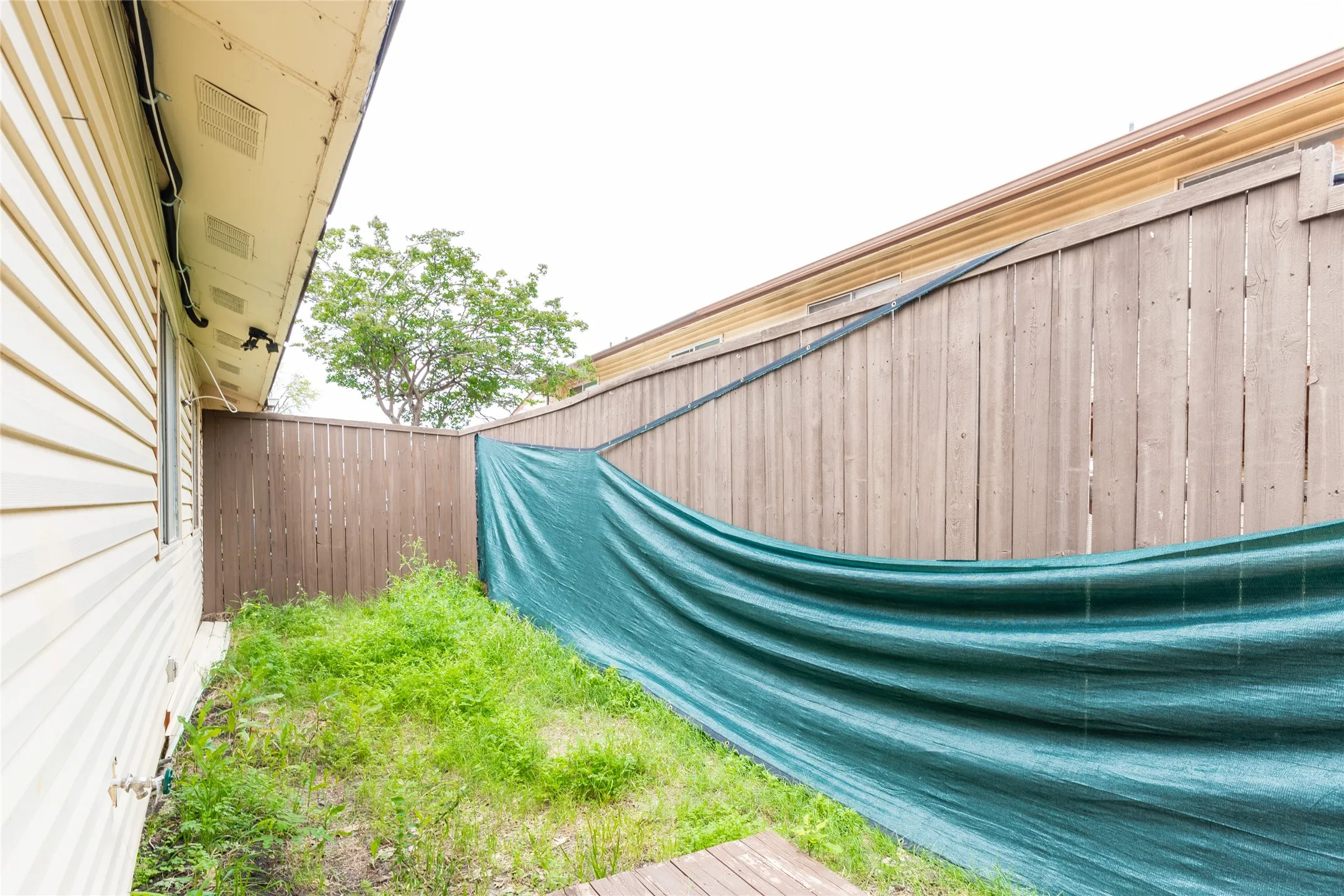 Rear yard with wood privacy fencing and vinyl siding